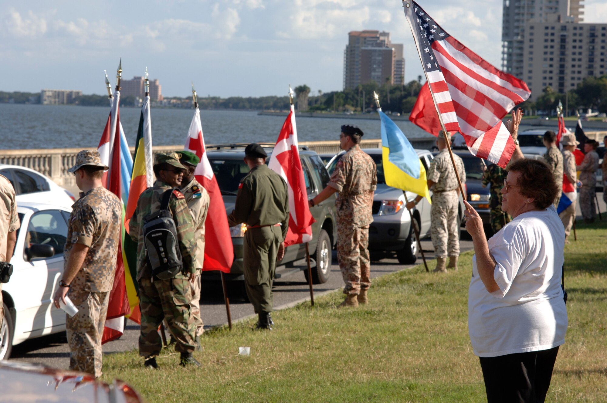 Members of the Bayshore Patriots, a Tampa community group, along with liaison officers from the 64 different nations attached to U.S. Central Command's Coalition Village, greeted Bayshore Boulevard drivers Sept. 12, the day after Patriots Day to show support and solidarity. Sept. 12 is the anniversary of the invoking of Article 5 by NATO, which states that an attack on one member country is an attack on all. 
(U.S. Air Force Photo by Staff Sgt. Ronnie Hill) 
