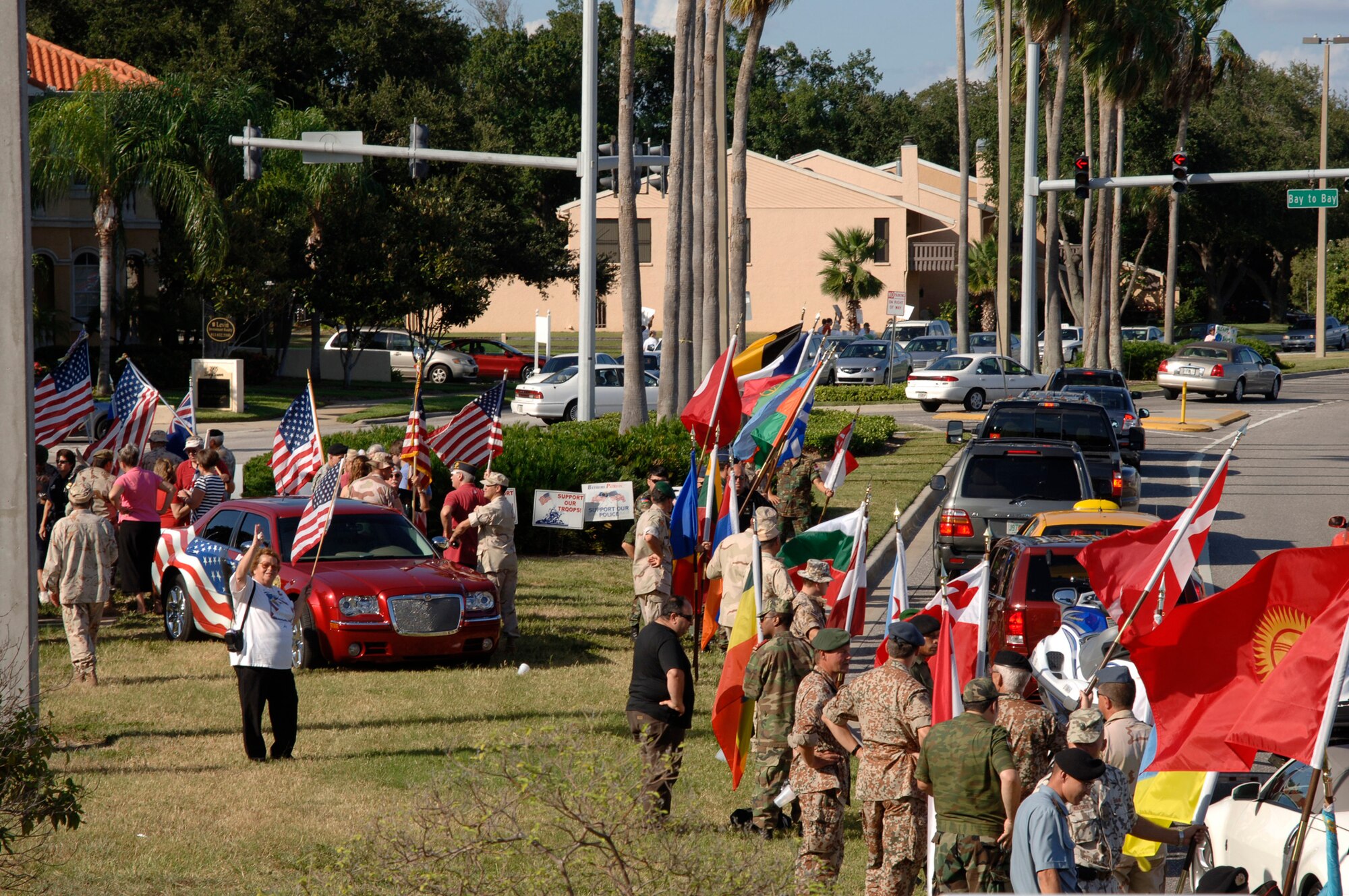 Members of the Bayshore Patriots, a Tampa community group, along with liaison officers from the 64 different nations attached to U.S. Central Command's Coalition Village, greeted Bayshore Boulevard drivers Sept. 12, the day after Patriots Day to show support and solidarity. Sept. 12 is the anniversary of the invoking of Article 5 by NATO, which states that an attack on one member country is an attack on all. 
(U.S. Air Force Photo by Staff Sgt. Ronnie Hill) 
