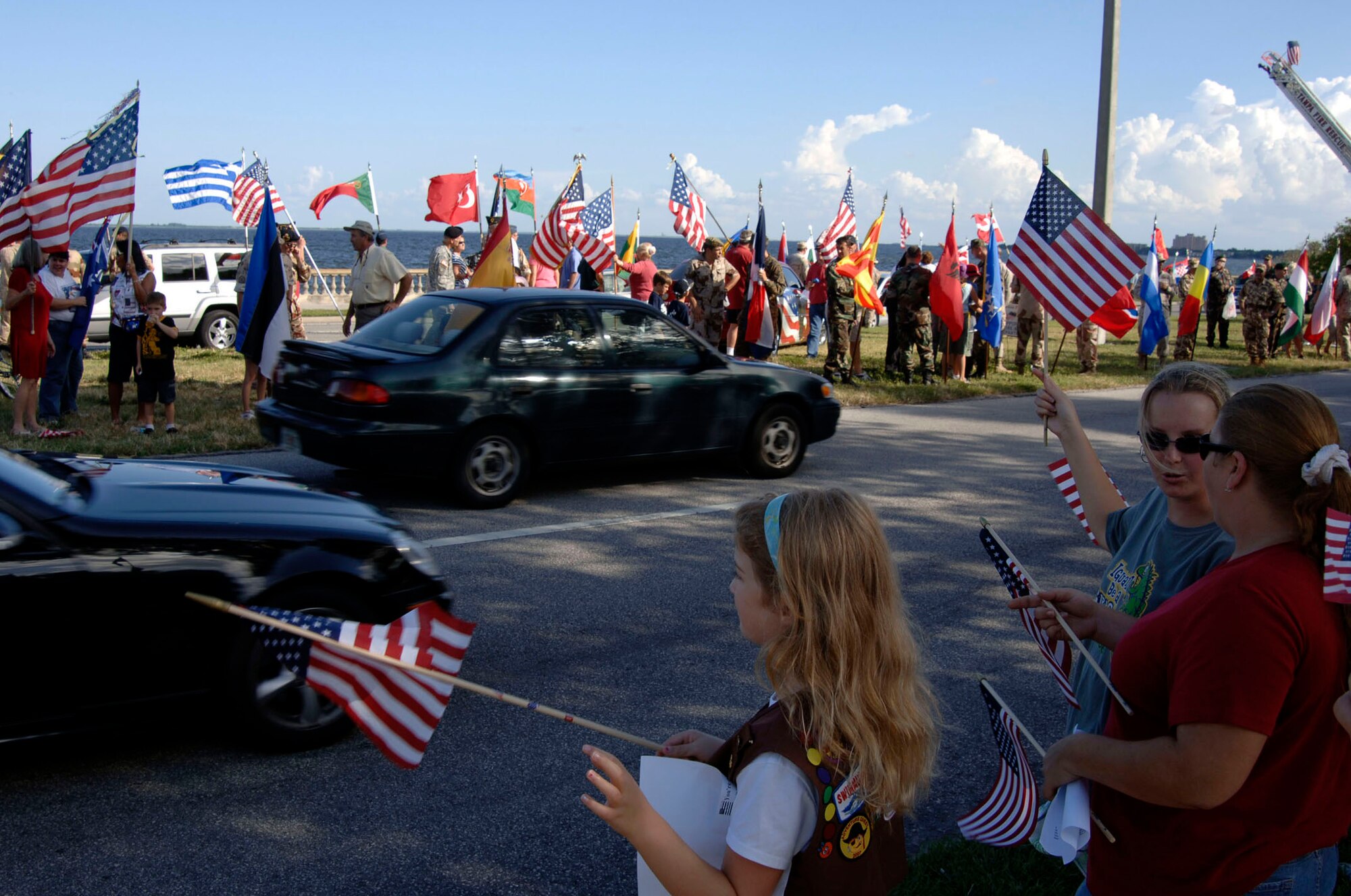 Members of the Bayshore Patriots, a Tampa community group, along with liaison officers from the 64 different nations attached to U.S. Central Command's Coalition Village, greeted Bayshore Boulevard drivers Sept. 12, the day after Patriots Day to show support and solidarity. Sept. 12 is the anniversary of the invoking of Article 5 by NATO, which states that an attack on one member country is an attack on all. 
(U.S. Air Force Photo by Staff Sgt. Ronnie Hill) 
