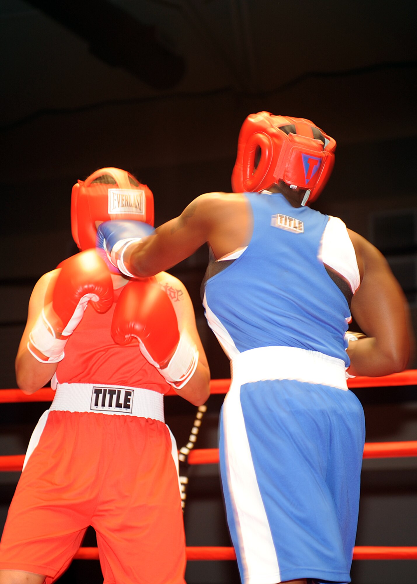 Tech. Sgt. Genese Williams, 49th Materiel Maintenance Support Squadron, lands a punch on Senior Airman Lauren Moss, 49th Aero-Medical Squadron, during their fight at the "Raptor Rumble 2," Sept. 12. Airman Moss and Sergeant Williams fought in the 140 weight class. (U.S Air force photo/ Airman 1st Class DeAndre Curtiss )