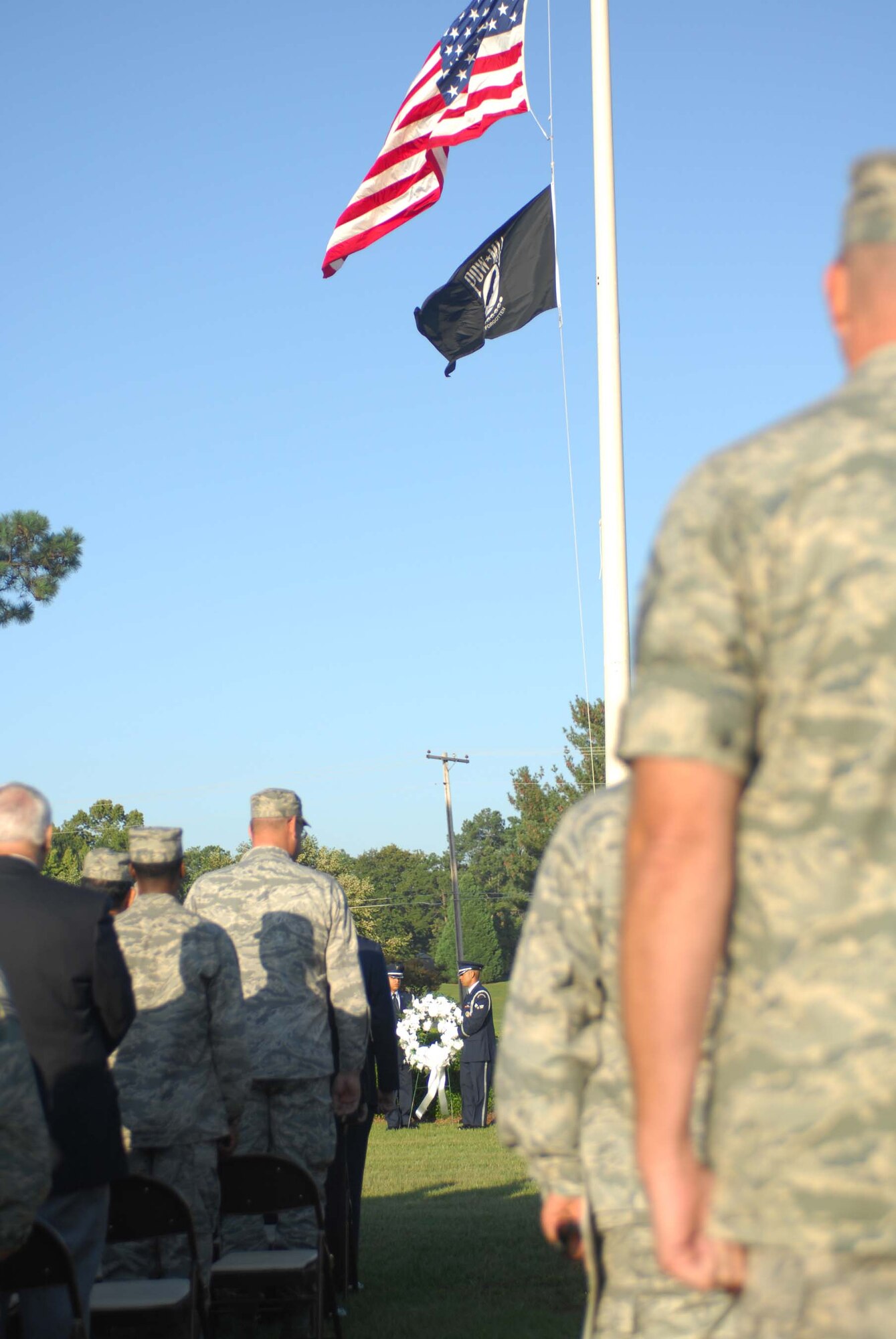 SHAW AIR FORCE BASE, S.C. -- Airmen of the 20th Fighter Wing stand at attention while the Honor Guard lay the ceremonial wreath Sept. 19 during the POW/MIA Ceremony hosted by Col. James Post, 20th FW commander. The ceremony started with a formation of Air Force and Army and concluded with a 21-gun salute, taps and a missing man fly by. Servicemembers of Shaw gathered for the ceremony to show appreciation to those who gave more of themselves than most. (U.S. Air Force photo/Staff. Sgt. Patrick Mitchell)