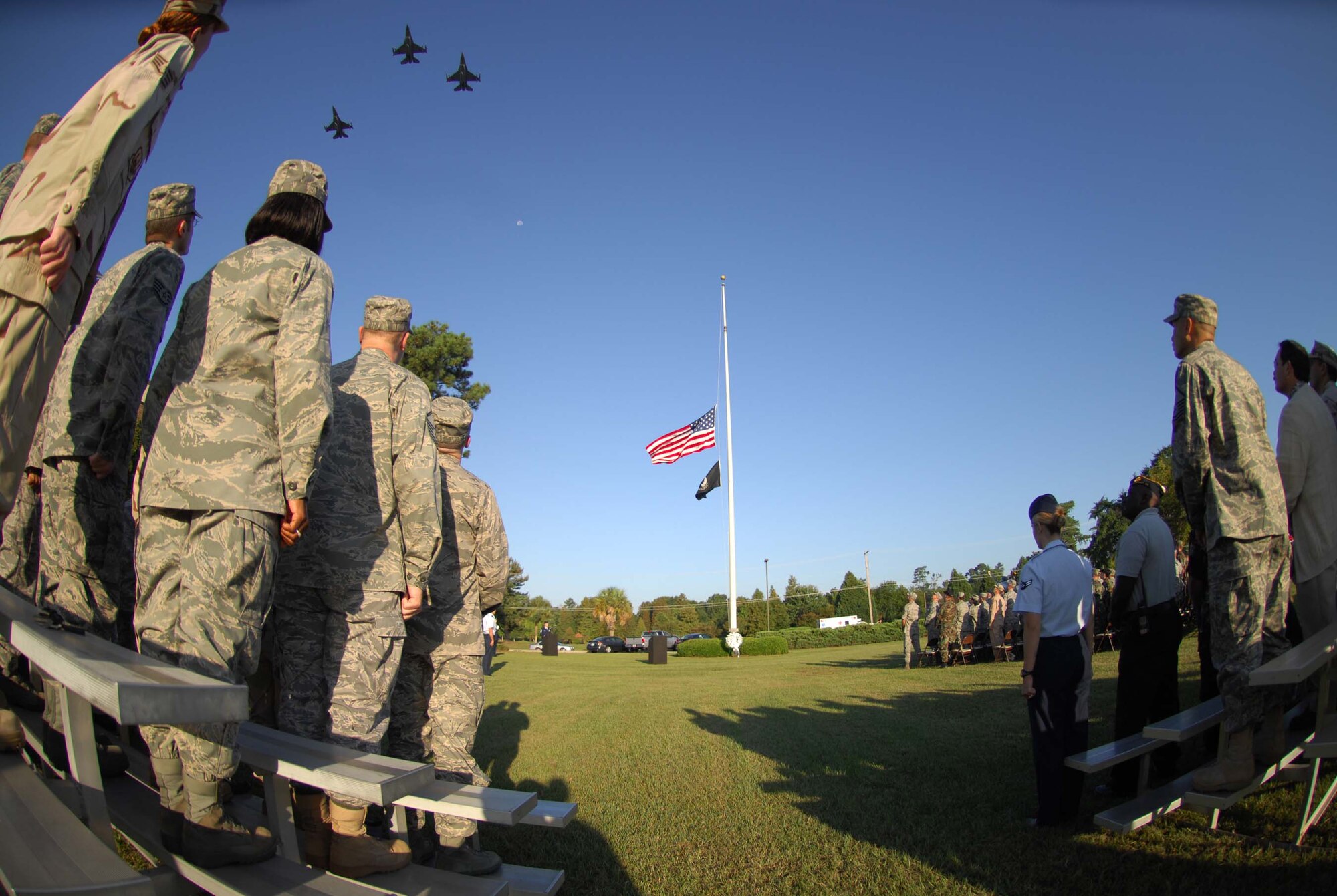 SHAW AIR FORCE BASE, S.C. -- Airmen of the 20th Fighter Wing stand at attention during the missing man fly-by formation Sept. 19 during the POW/MIA Ceremony hosted by Col. James Post, 20th FW commander. The ceremony started with a formation of Air Force and Army and concluded with a 21-gun salute, taps and a missing man fly by. Servicemembers of Shaw gathered for the ceremony to show appreciation to those who gave more of themselves than most. (U.S. Air Force photo/Staff. Sgt. Patrick Mitchell)