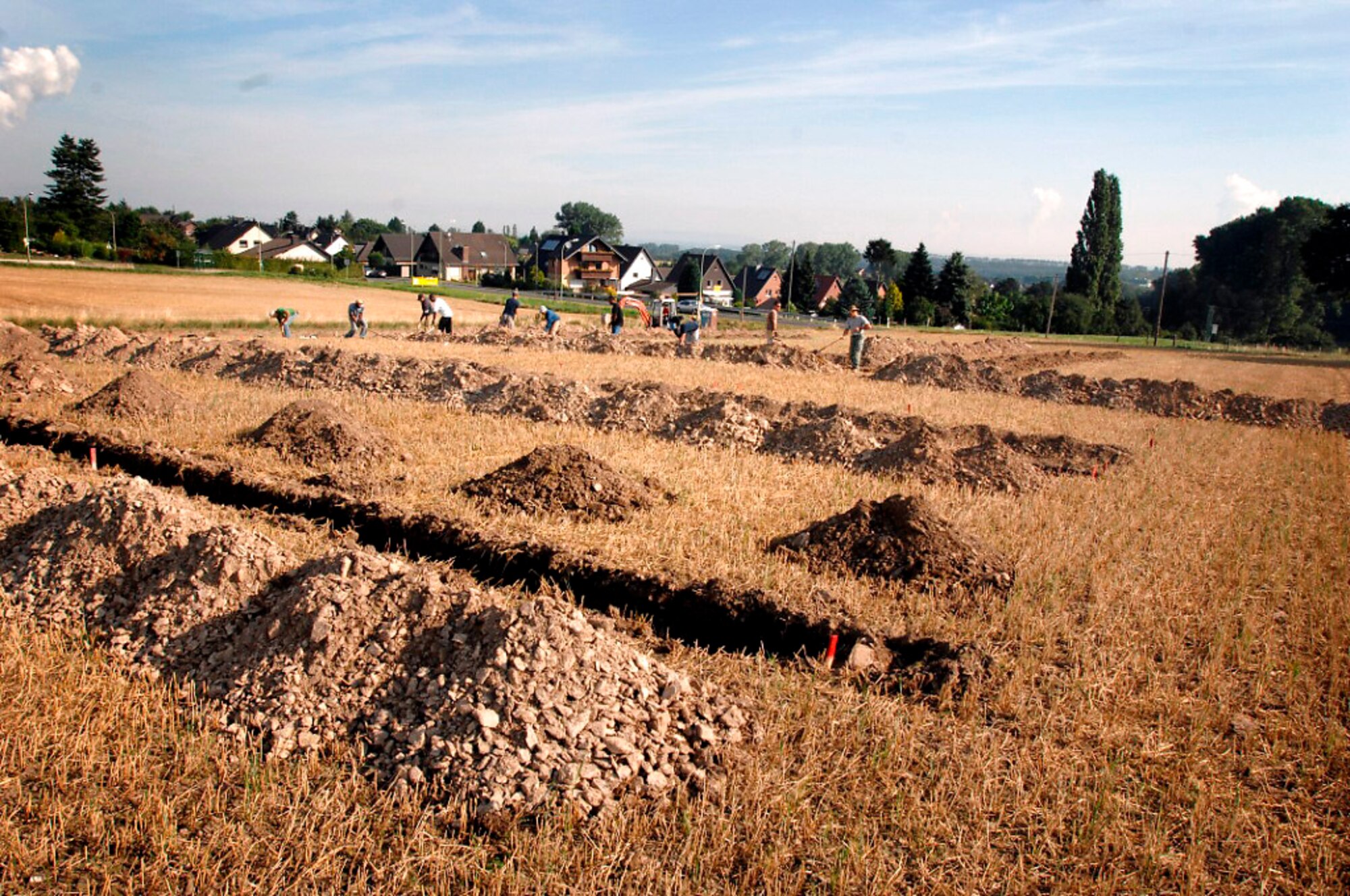 Test trenches are dug into a wheat field outside of Strass village in Germany. The Joint POW/MIA Accounting Command recovery team was there last month to recover the remains of a missing World War II fighter pilot. (Department of Defense photo/Fred W. Baker III) 
