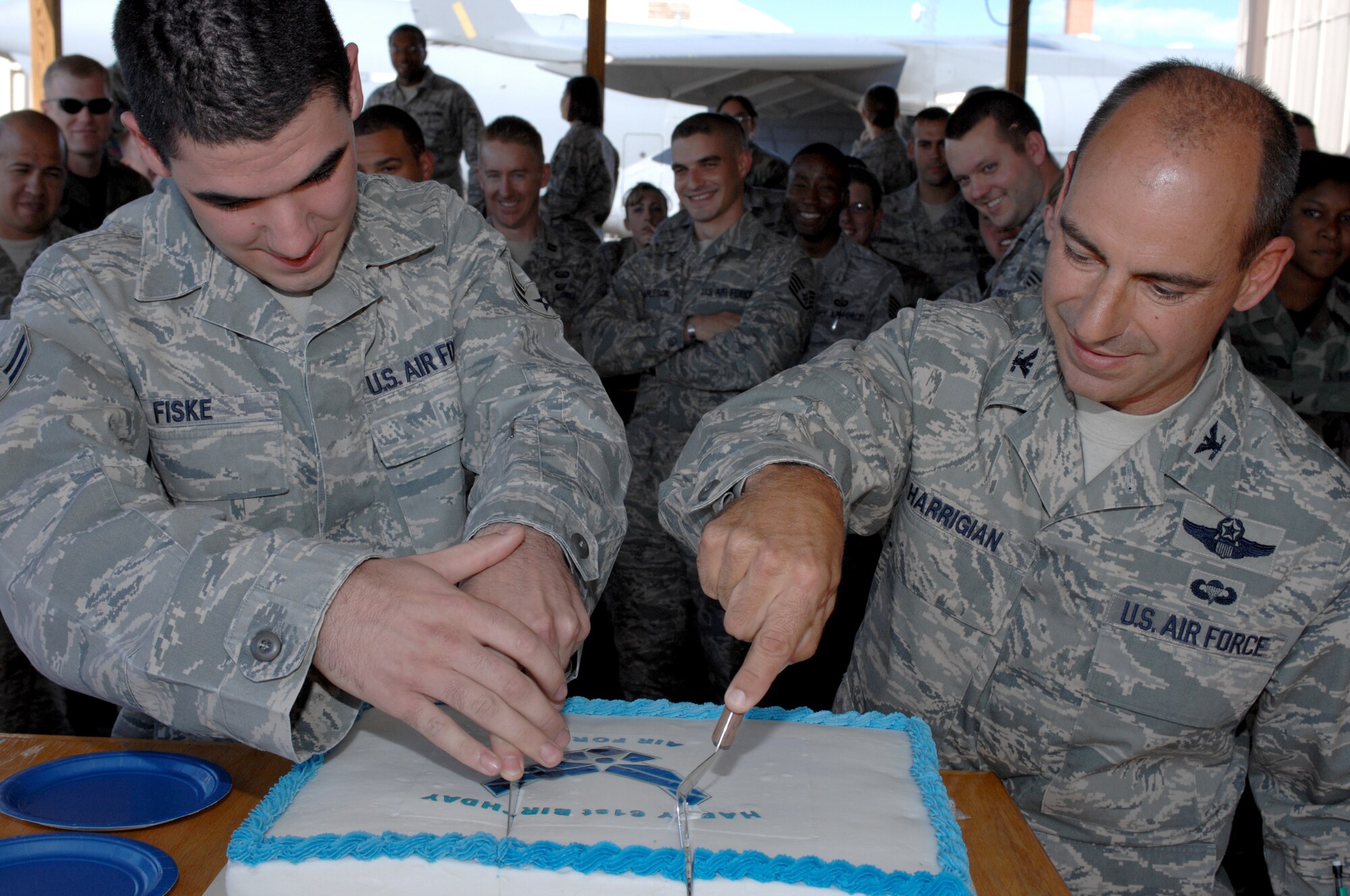 Airman 1st Class Joshua Fiske, 49th Operations Support Squadron, and Col. Jeff Harrigian, 49th Fighter Wing commander, execute the honors of cutting the cake at the Air Force birthday celebration outside the 7th Fighter Squadron at Holloman Air Force Base, N.M., September 16. Airman Fiske was chosen as he is the youngest member of the 49 OSS. The cake was in honor of the Air Force?s 61st Birthday. (U.S. Air Force photo/Airman Sondra M. Escutia)