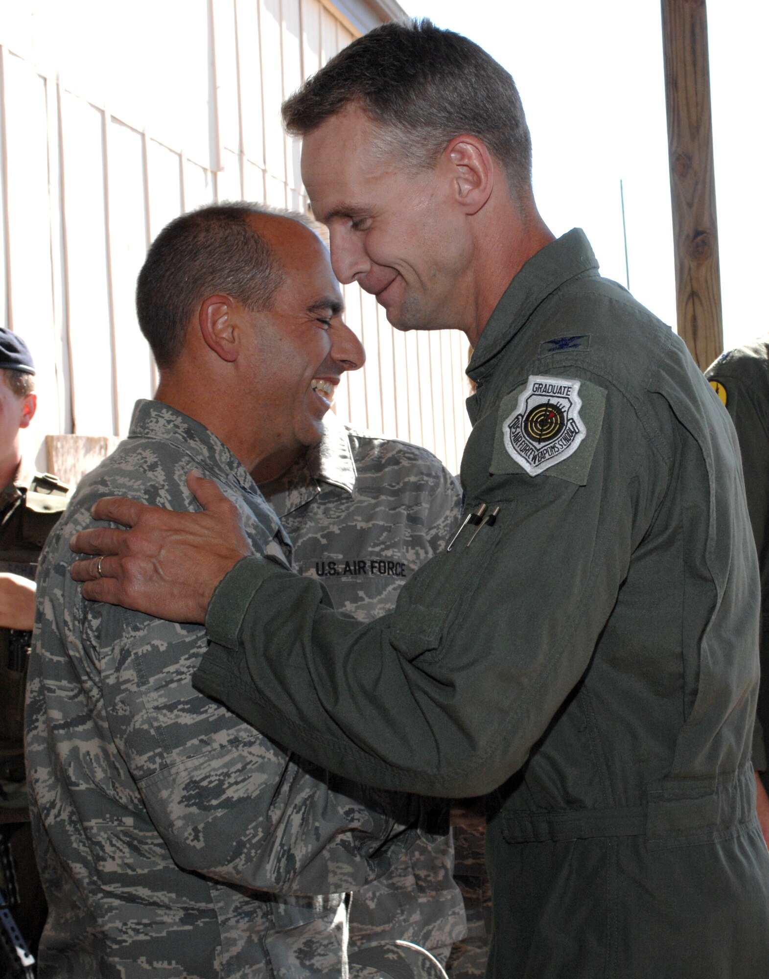 Col. Michael Stapleton, 49th Operations Group commander, shakes the hand of Col. Jeff Harrigian, 49th Fighter Wing commander, at the Air Force birthday celebration outside the 7th Fighter Squadron at Holloman Air Force Base, N.M., September 16. Colonel Harrigian executed the honors of cutting the cake along with Airman 1st Class Joshua Fiske, 49th Operations Support Squadron, in honor of the Air Force?s 61st birthday. (U.S. Air Force photo/Airman Sondra M. Escutia)
