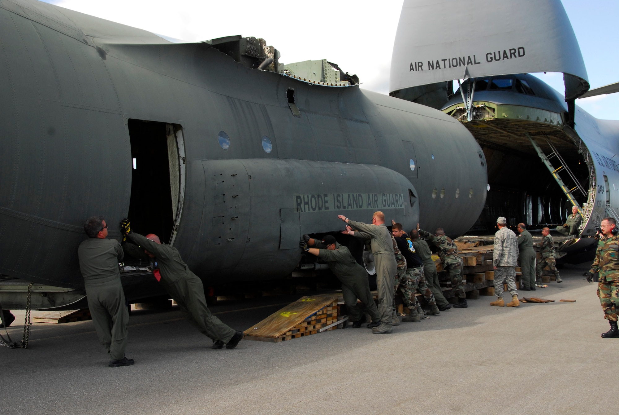 STRATTON AIR NATIONAL GUARD BASE, N.Y. -- Guardsmen help push a C-130 fuselage out of a C-5. The training fuselage was transported from the Rhode Island Air National Guard. Loadmasters, aeromeds and aerial port personnel will now be able to train at any time. 