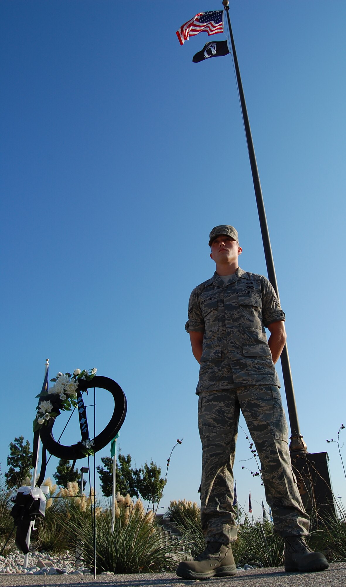 LAUGHLIN AIR FORCE BASE, Texas -- Airman 1st Class Sam Kearney, 47th Installation Support Squadron, stands in silent vigil over a display honoring America's Prisoners of War and Missing in Action Sept. 19.  Laughlin Airmen stood guard at the base flagpole in 30-minute shifts from 5 a.m. to 5 p.m. in observation of National POW/MIA Remembrance Day, which is always the third Friday in September.  (U.S. Air Force photo by Staff Sgt. Austin M. May)