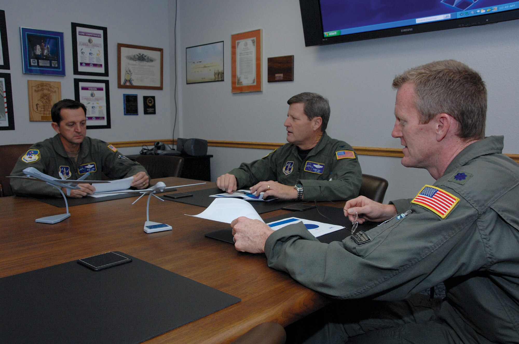 (Left to right) Lt. Col. Michael Lane, 163d Operations Support Flight commander, Col. Randall Ball, 163d Operations Group commander, and Lt. Col. Kirby Colas, 196th Reconnaissance Squadron commander, discuss preparations for the 163d Reconnaissance Wing's Predator flight training operations sheduled to begin in 2009. (Photo by Senior Airman Paul Duquette)