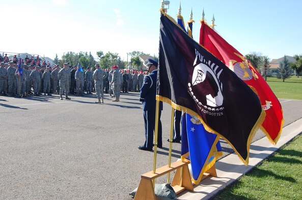 The POW/MIA flag waves along with flags from each branch of the military while members of Team Malmstrom prepare for the POW/MIA retreat ceremony to begin. The ceremony was held Sept. 17 at Medal of Honor park. (U.S. Air Force photo/Senior Airman Emerald Ralston)
