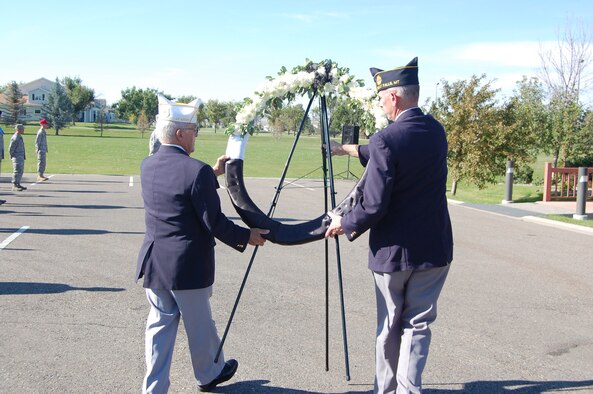 Sam Pappas, commander American Legion Post 3, and David Driver, Past Deputy Zone 3 commander, carry a commemoration wreath to the flag during a POW/MIA retreat ceremony Sept. 17 at Medal of Honor park. (U.S. Air Force photo/Senior Airman Emerald Ralston)