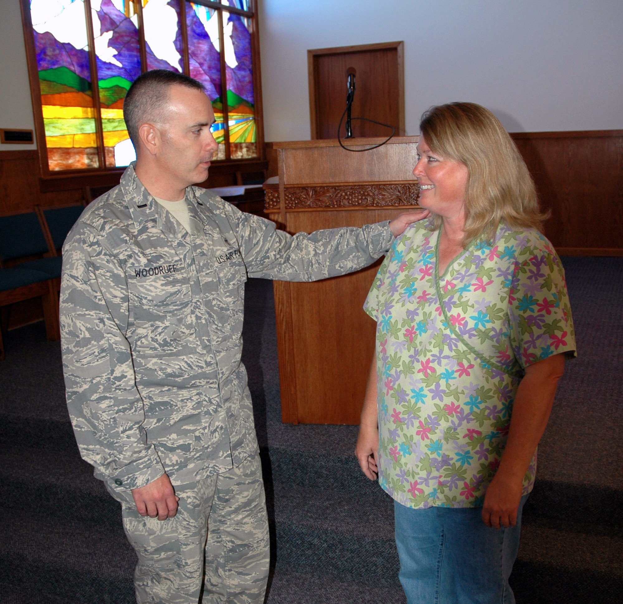 Chaplain (1st Lt.) Thomas Woodruff, 341st Missile Wing chaplain, speaks with Janet Smith, Protestant religious education coordinator, in the base chapel sanctuary Sept. 15. (U.S. Air Force photo/ Airman 1st Class Dillon White)