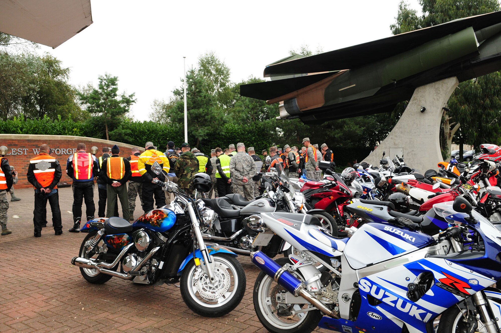 Motorcyclists gather at Memorial Park on RAF Lakenheath and bow their heads as the base chaplain reads a prayer in honor of prisoners of war and those missing in action, as part of POW/MIA Week. (U.S. Air Force photo by Karen Abeyasekere)