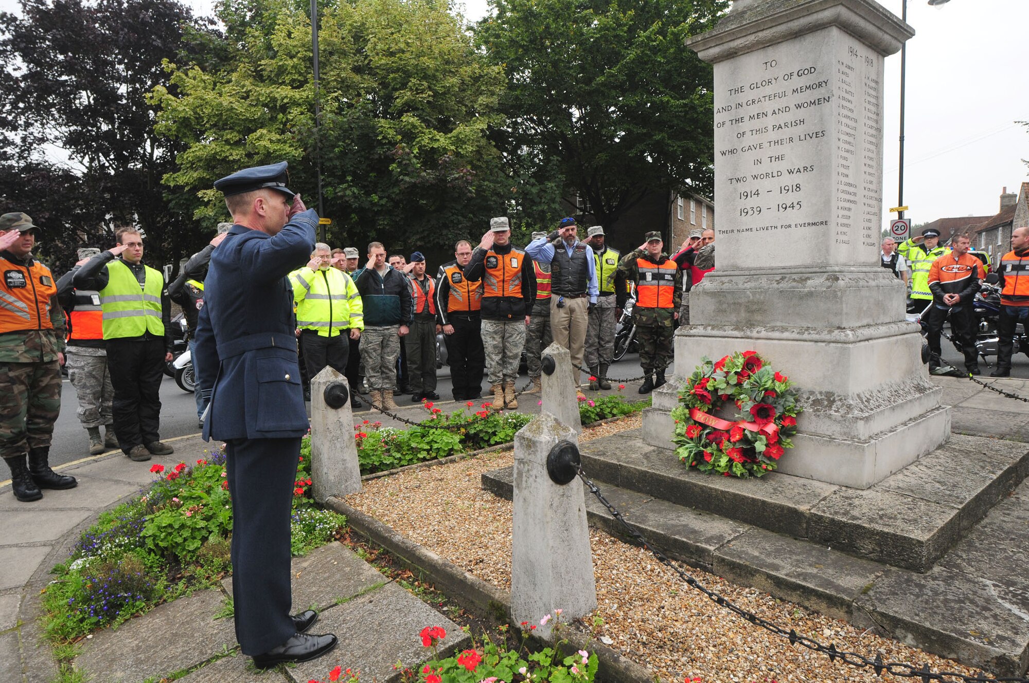 Squadron Leader Rick Fryer, RAF Station Commander, and motorcyclists from RAFs Mildenhall and Lakenheath salute after a wreath was laid at the British war memorial in Mildenhall. As part of Prisoner of War/Missing in Action week, the motorcyclists presented wreaths which were laid at RAF Mildenhall, Mildenhall High Town, and RAF Lakenheath. (U.S. Air Force photo by Karen Abeyasekere)