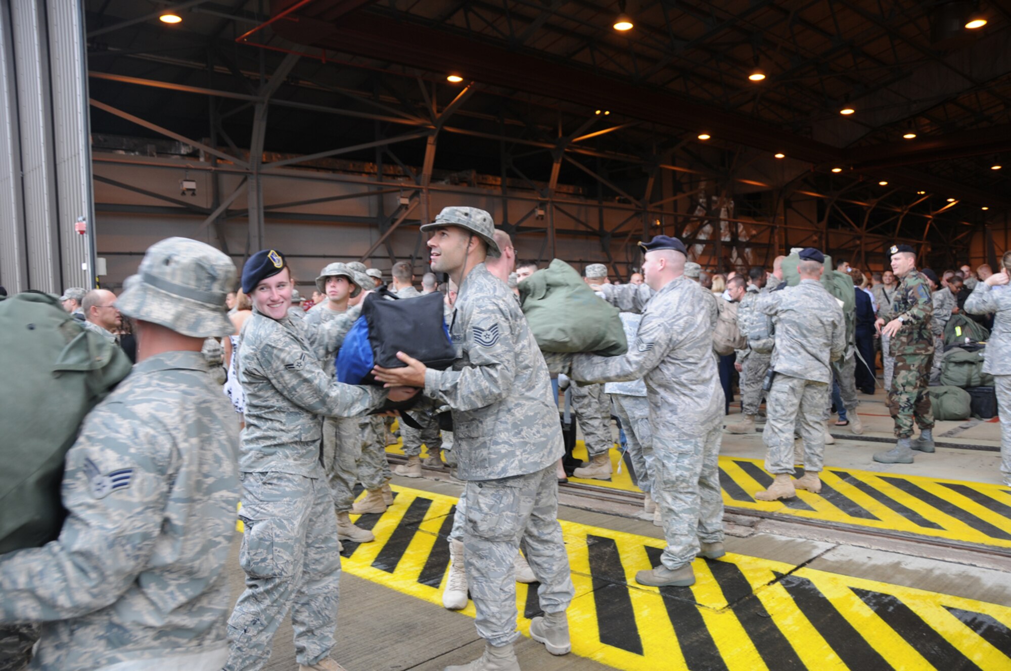 Several Airmen helped unload bags from the bus carrying deployment returnees Sept. 8 at RAF Lakenheath, England. The 48th Fighter Wing welcomed home more than 200 of its deployed members. (U.S.Air Force photo by Tech. Sgt. J. LaVoie)