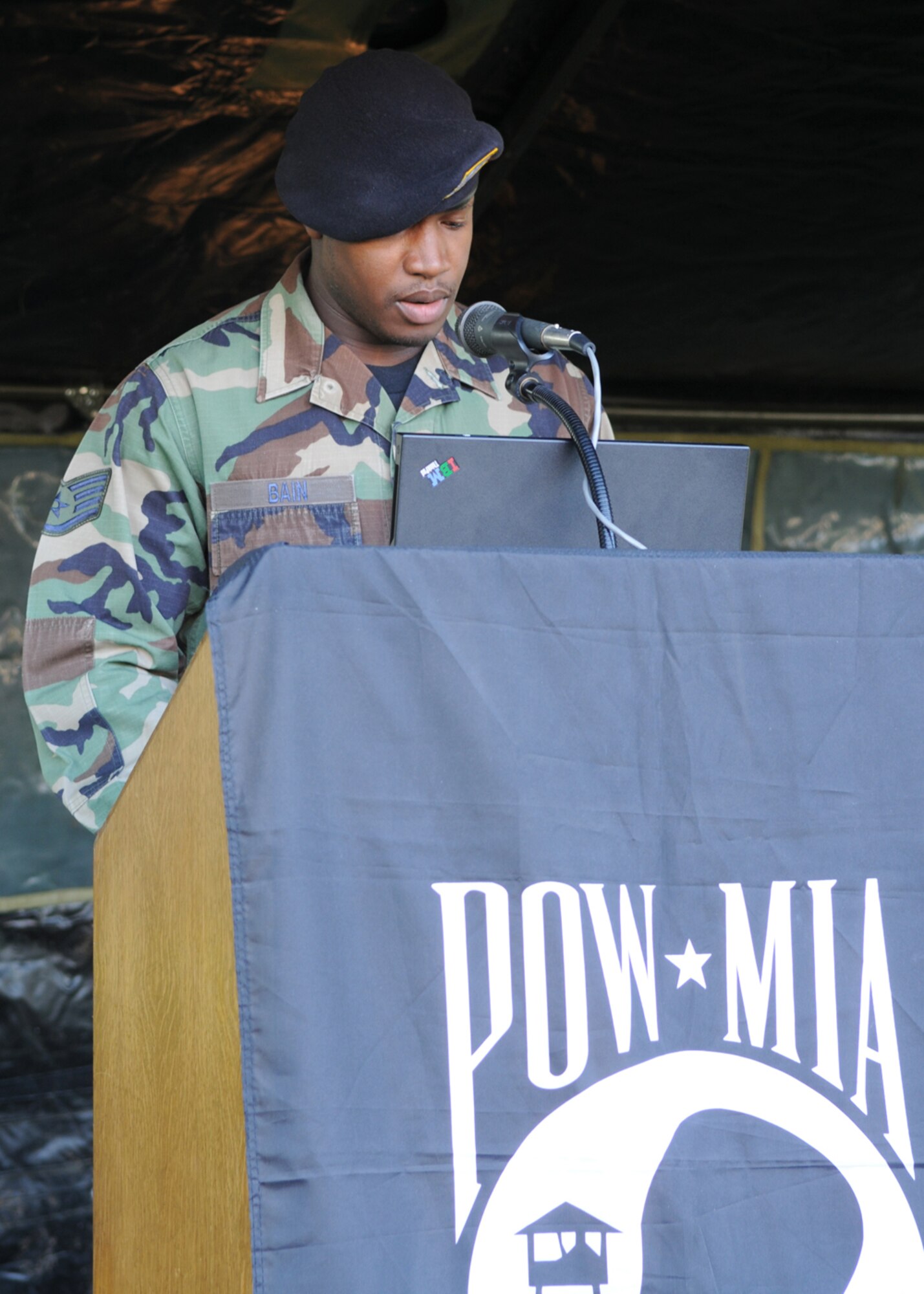 Staff Sergeant Che Bain, from the 100th Security Forces Squadron, reads names of servicemembers who were captured or missing in action during the Prisoner of War/Missing in Action memorial at RAF Mildenhall, England Sept. 19, 2008. Sergeant Bain was one of many volunteers who would read names for five minutes, and then post guard at the memorial for an additional five minutes. (U.S. Air Force Staff Sergeant Jerry Fleshman)