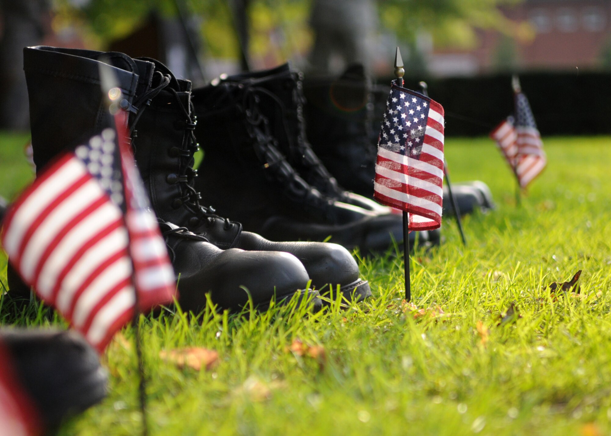 Tiny American flags and a row of combat boots sit together during the Prisoner of War/Missing in Action 24-hour vigil ceremony during POW/MIA week, Sept. 18, 2008 at RAF Mildenhall, England. The flags represents American freedom, while the boots serve as a humbling reminder of sacrifices given by our captured and fallen servicemembers. (U.S. Air Force photo by Staff Sergeant Jerry Fleshman)