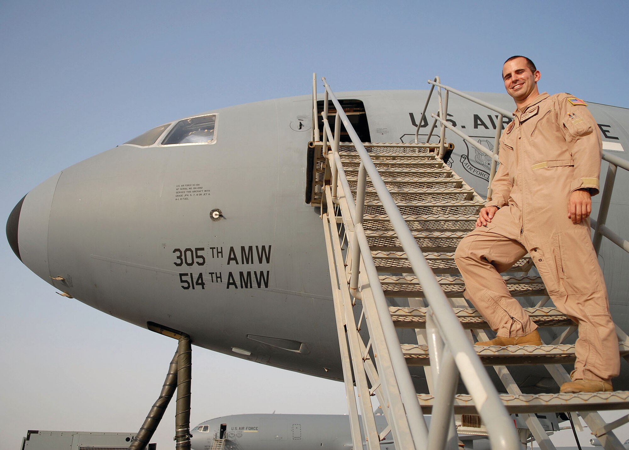 Capt. Jason Moraes, KC-10 pilot for the 908th Expeditionary Air Refueling Squadron, prepares to head out on a night mission from the 380th Air Expeditionary Wing Sept. 17. Captain Moraes recently had the rare opportunity of refueling his brother's B-1B Lancer aircraft 20,000 feet over a combat zone. (U.S. Air Force photo/Tech. Sgt. Denise Johnson)