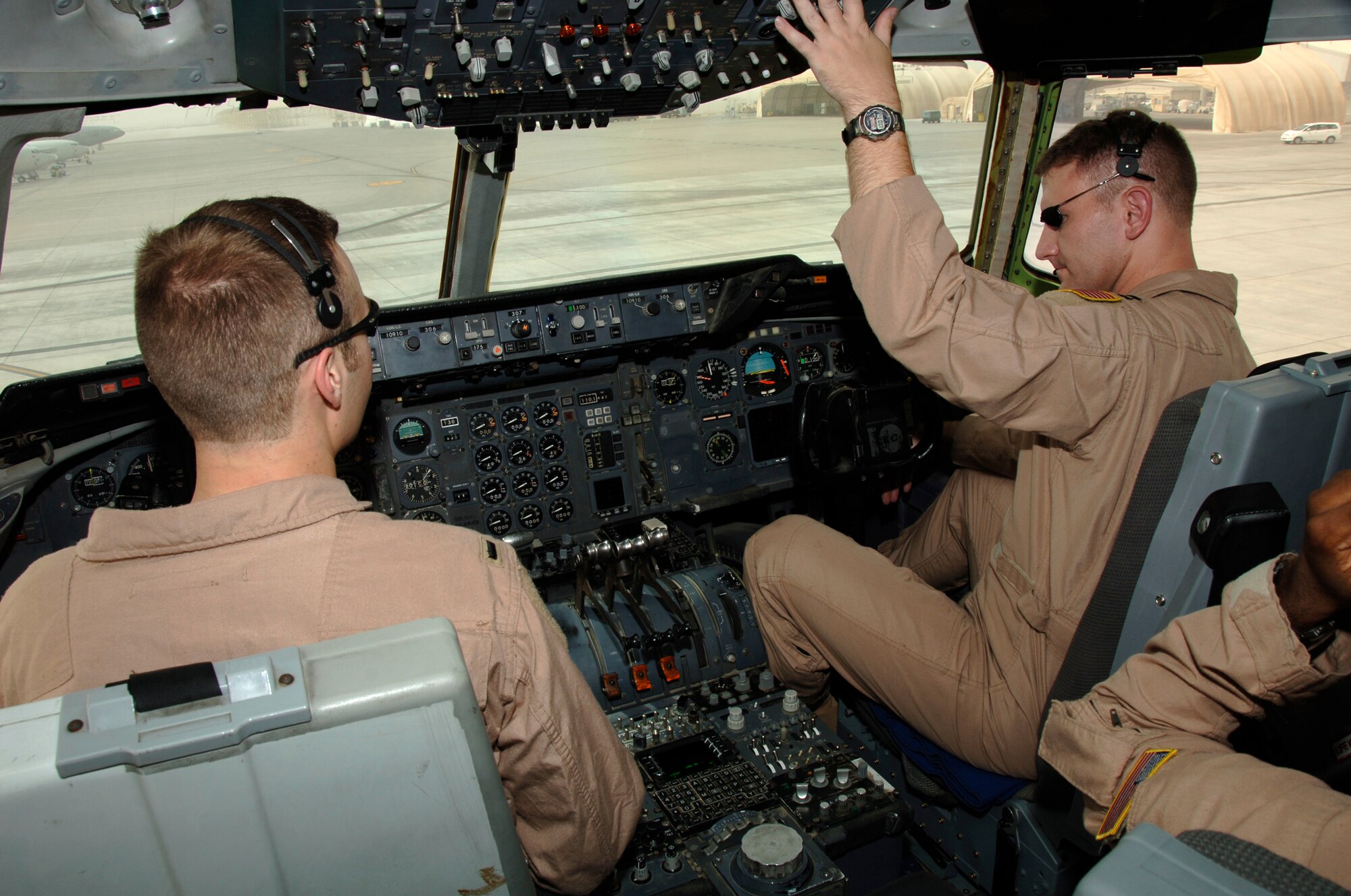SOUTHWEST ASIA -- Capt. Cory Benton performs preliminary cockpit system checks while 1st Lt. Tim Carapetyan observes the checks here Sept. 16. Both are from the 908th Expeditionary Air Refueling Squadron, which flies numerous refueling sorties in direct support of the war on terrorism in Southwest Asia. Capt. Benton, a native of Brilliant, Ohio, and Lieutenant Carapetyan from Wehrheim, Germany, are deployed from the 32nd ARS McGuire Air Force Base, N.J.(U.S. Air Force photo/Tech. Sgt. Christopher A. Campbell)(released)