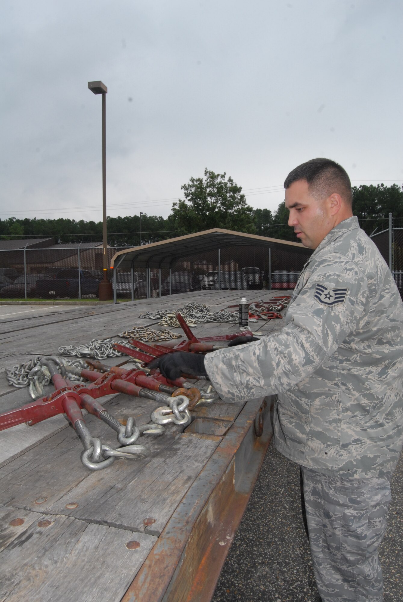 Staff Sgt. Robert Yazinka, 43rd Logistics Readiness Squadron, prepares tie-down equipment for a tractor-trailer run. (U.S. Air Force Photo by Emily Smith)