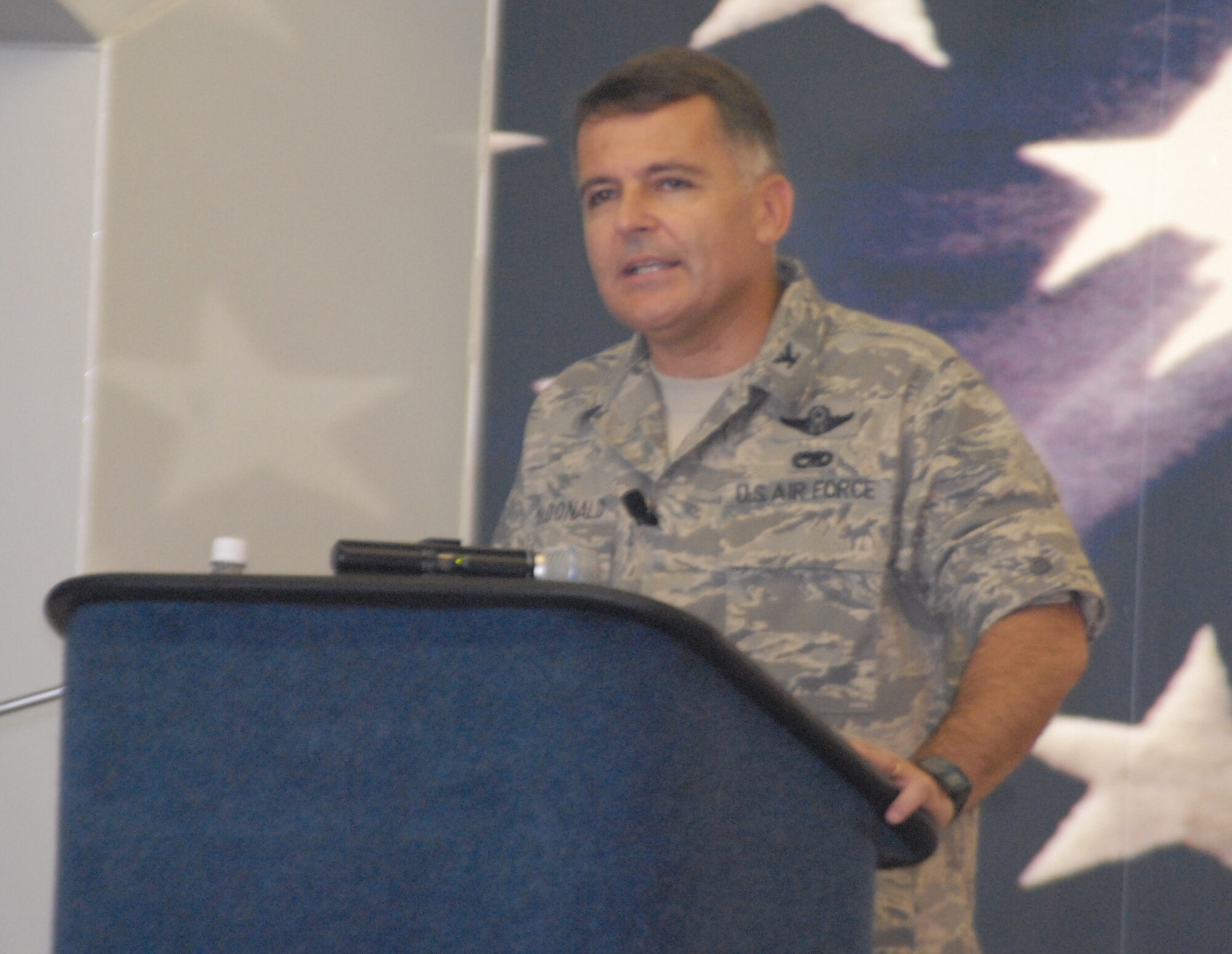 Col. John McDonald, 43rd Airlift Wing Commander, addresses the attendees during the Patriot Day remembrance ceremony Sept. 11 at Hangar 4 on Pope. Colonel McDonald spoke of the sacrifices made that day and asked all members to remember the two Pope servicemembers lost since the Sept. 11 attacks. (U.S. Air Force Photo by Tech. Sgt. Todd Wivell)