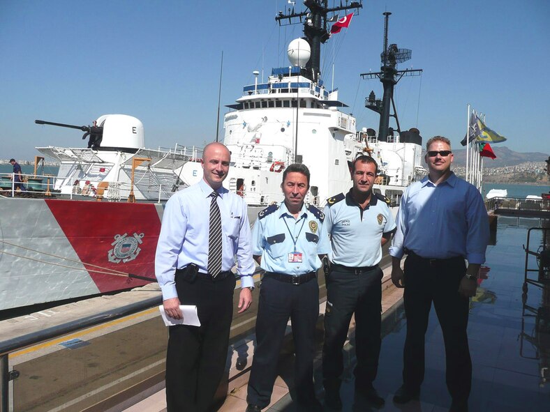 The U.S. Coast Guard cutter Dallas visits the port of Izmir, Turkey. The Dallas was returning from a Black Sea tour where it delivered humanitarian assistance to Georgia. Air Force Office of Special Investigations, Detachment 523 coordinated with the Turkish National Police to arrange appropriate Force Protection measures including a local threat briefing to the ship's captain and his senior staff. AFOSI Det. 523 supports numerous U.S. ships attached to the U.S. Navy 6th Fleet during visits to Turkish ports. Pictured are (l to r) Special Agent Seth Volk, two Turkish sea police officers and Special Agent Frank Mosura. (U.S. Air Force photo)