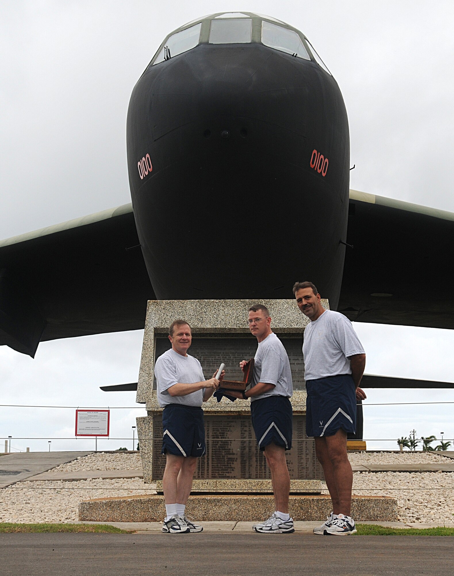 ANDERSEN AIR FORCE BASE, Guam - Brigadier Gen, Phil Rulman accepts the baton presented by Master Sgt. Kelly Halferty to mark the start of the 24-hour POW/MIA observance run at Arc Light Memorial Park Sept. 18. (U.S. Air Force photo by Staff Sgt. Jamie Lessard)