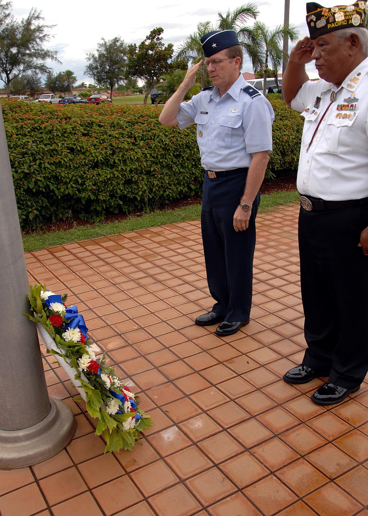 ANDERSEN AIR FORCE BASE, Guam - Brigadier Gen. Philip Ruhlman, 36th Wing Commander, and U.S. Military Veteran Raymond Baza salute the POW/MIA wreath during a retreat ceremony held in remembrance of past and present POW/MIAs Sept. 19 here. (U.S. Air Force photo by Airman 1st Class Nichelle Griffiths)
