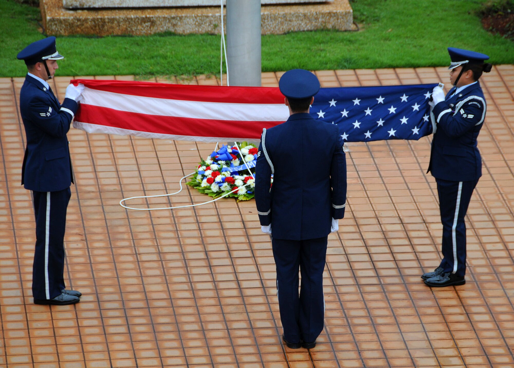 ANDERSEN AIR FORCE BASE, Guam -- Team Andersen honor guard members fold the flag as "Retreat" plays during the POW/MIA Retreat Ceremony here Sept. 19. This year's retreat kicked off with a 24-hour run at Arc Light Memorial Park. (U.S. Air Force photos by Airman 1st Class Courtney Witt)