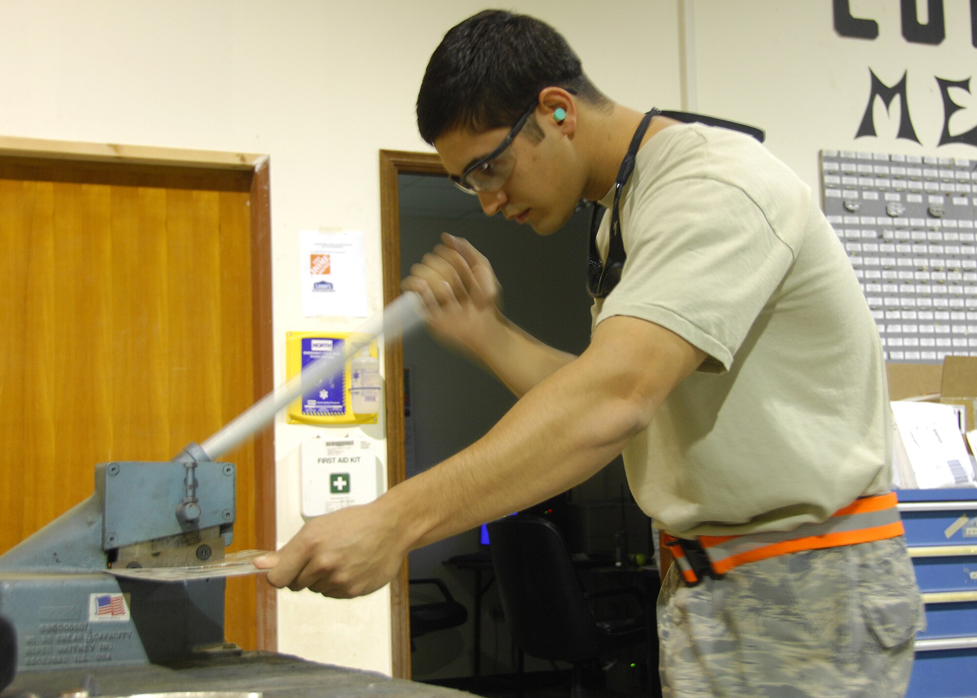 SOUTHWEST ASIA -- Senior Airman Albert Pagan, 386th Expeditionary Maintenance Squadron Combat Metals section, cuts out a flush patch for an aircraft repair on Sept. 17 at an air base in Southwest Asia. The Combat Metals shop performs aircraft sheet metal fabrication, structural repairs and modifications for aircraft. Airman Chang is deployed from Yokota Air Base, Japan (U.S. Air Force photo/Tech. Sgt. Raheem Moore)