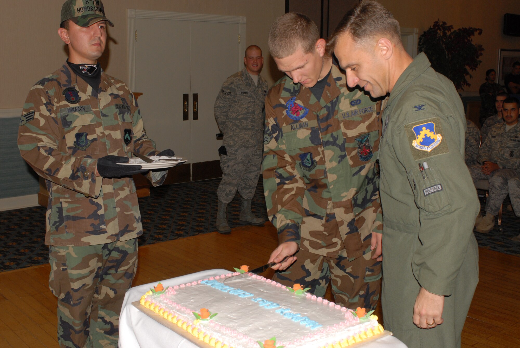KUNSAN AIR BASE, Republic of Korea -- Airman Matthew Allman, 8th Civil Engineer Squadron (center), and Col. Bryan "Wolf" Bearden, 8th Fighter Wing commander (right), cut the cake during the Air Force Birthday Ceremony here, Sept. 18. The Ceremony was coordinated by First Term Airman Center students to celebrate  61 years of Air Force heritage. (U.S. Air Force photo/Senior Airman Gustavo Gonzalez)
