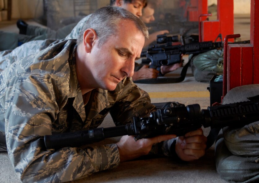 KUNSAN AIR BASE, Republic of Korea -Col. Jon "Wolf 2" Huss, 8th Fighter Wing vice commander lays in the prone position and familiarizes himself with the an M-4 carbine here Sept. 17. Wing leadership spent the morning at the base firing range learning to shoot the M-4 carbine and qualifying on the tactical rifle qualification course. They also learned about the nomenclature of the M-4 carbine and got a chance to practice shooting in different tactical positions.  (U.S. Air Force photo by Senior Airman Dana Hill)
