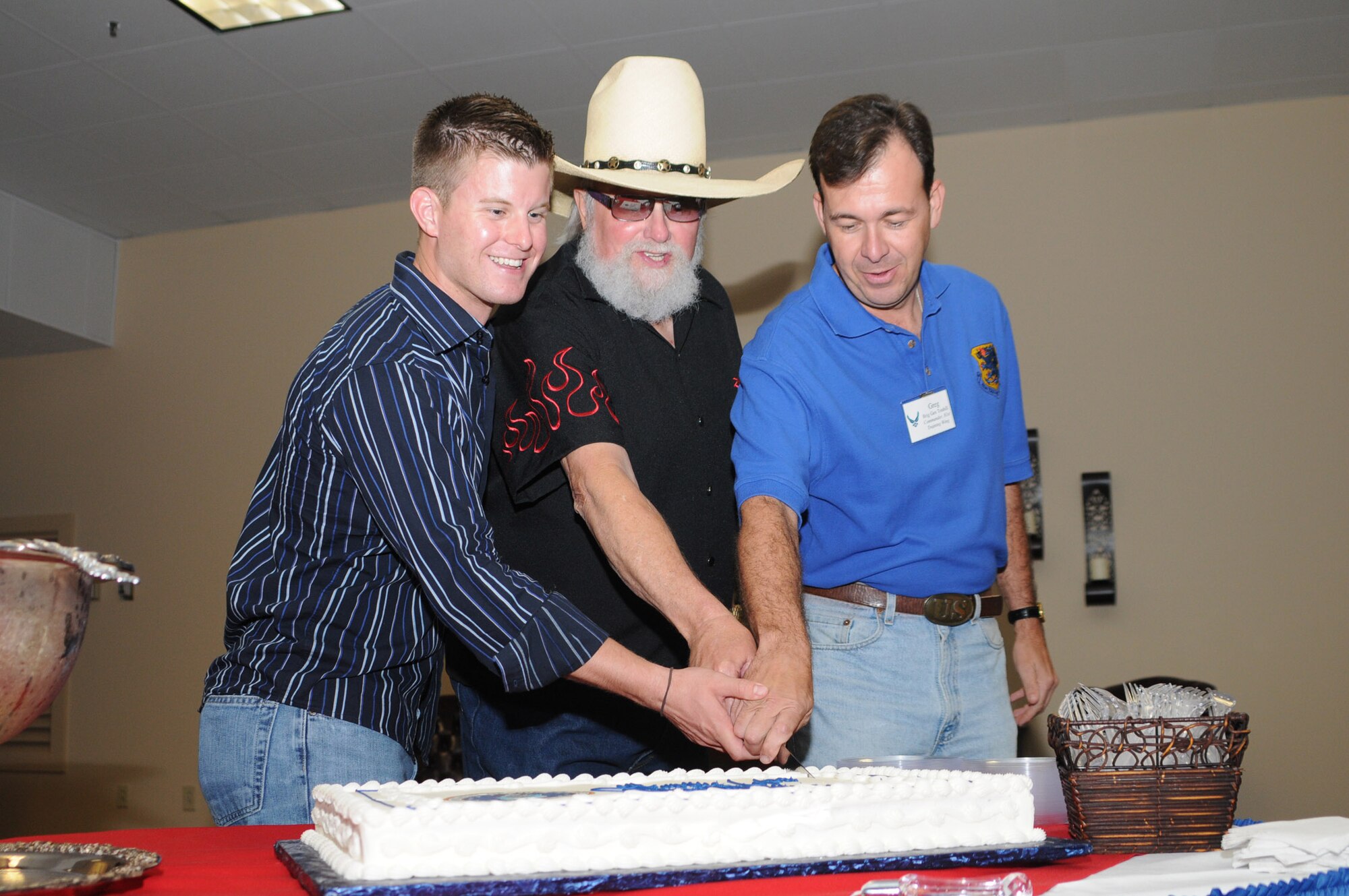 From left to right:  1st Lt. Logan Smith, 81st Civil Engineer Squadron, Charlie Daniels and Brig. Gen. Greg Touhill, 81st Training Wing commander, join to cut the Air Force birthday cake during a pre-concert reception with Mr. Daniels.  Lieutenant Smith is the godson of the famous vocalist.  As part of Keesler Air Force Base's Air Force birthday celebration, the Charlie Daniels Band played a concert for Airmen, families and local community members.  (U.S. Air Force photo by Kemberly Groue)