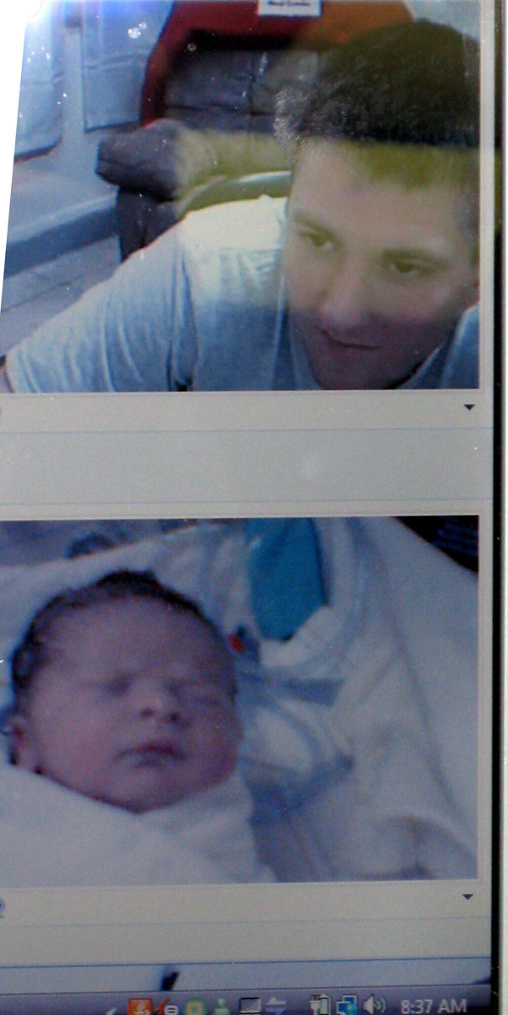 Airman 1st Class Roger Prokes, 95th Security Forces Squadron patrolman, looks at his daughter Emma for the first time, via webcam from Iraq. Emma was born on Sept. 11at 8:25 a.m. Staff at the San Antonio Community Hospital in Rancho Cucamonga, Calif., broadcast the live birth from their operating room for the first time.(Courtesy photo)