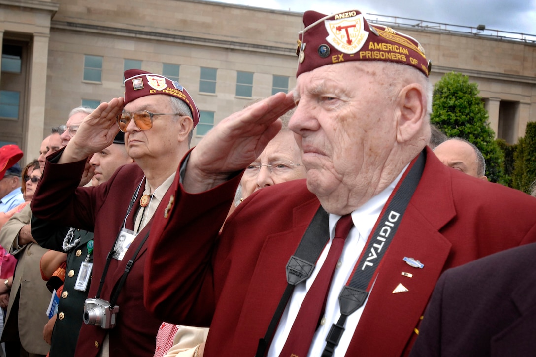 John Meyers, Maryland state commander for American Ex-Prisoners of War, front, and Steve Czecha, Maryland chapter officer for AXPOW, salute during a pass-in-review at the the National POW/MIA Recognition Day ceremony at the Pentagon today. Both were prisoners of war for about four months during World War II. 