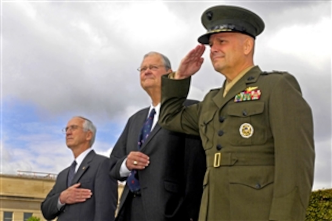 Deputy Secretary of Defense Gordon England, left, U.S. Rep. Ike Skelton, center, of Missouri, and U.S. Marine Corps Gen. James Cartwright, right, vice chairman of the Joint Chiefs of Staff, render honors during the annual Pentagon observance of National POW/MIA Recognition Day, Sept. 19, 2008.