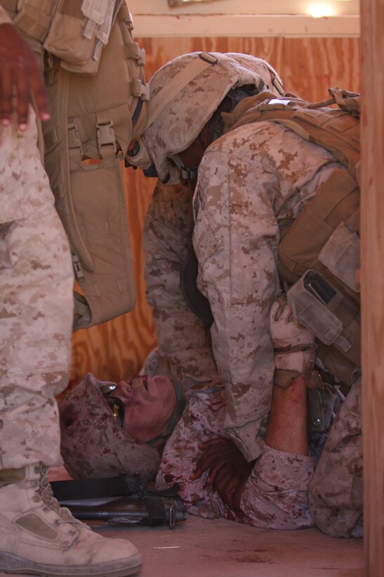 Marines with 3rd Battalion, 8th Marine Regiment treat casualties from at mock explosion during a first responder drill in a mock Afghan town at Range 215 as part of an Afghanistan-centered Mojave Viper at the Combat Center Sept. 20.