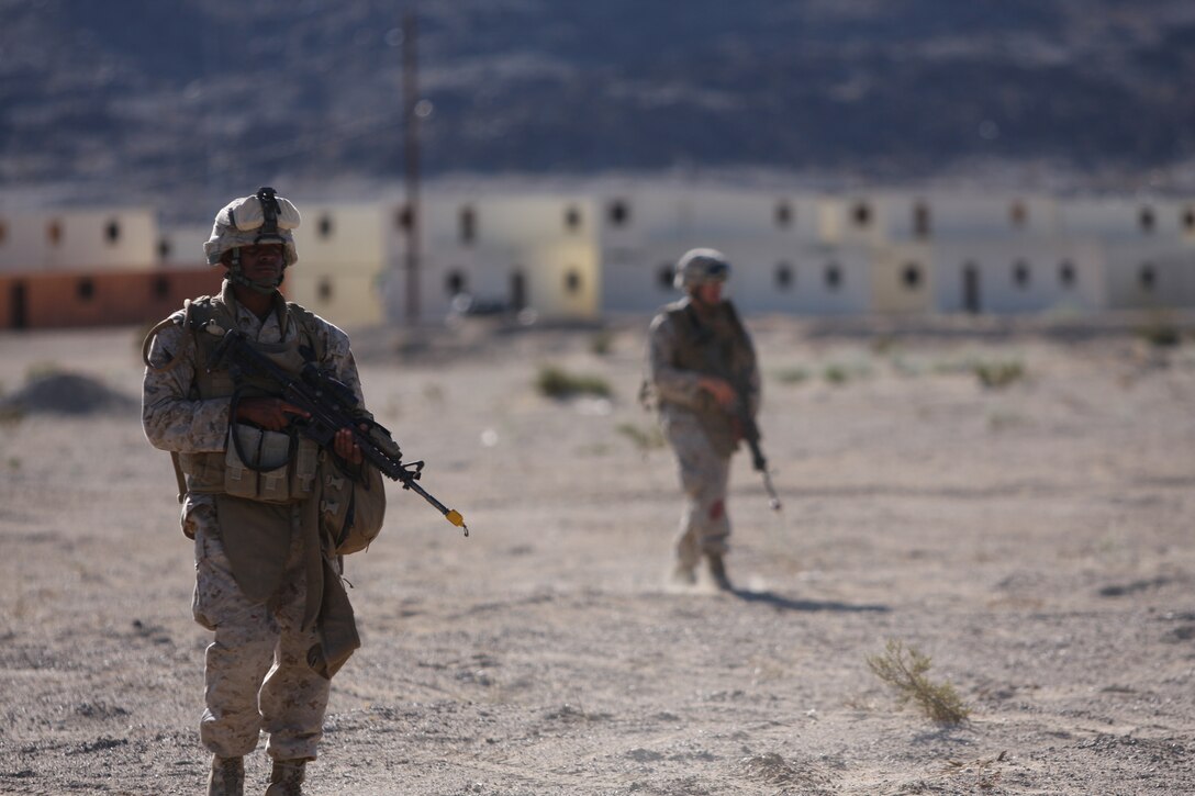 Seaman Tahlon Johnson, a hospital corpsman with Company K, 3rd Battalion, 8th Marine Regiment, patrols with the rest of his platoon back to the company’s Forward Operating Base just outside a mock Afghan town at Range 215 as part of an Afghanistan-centered Mojave Viper at the Combat Center Sept. 20.