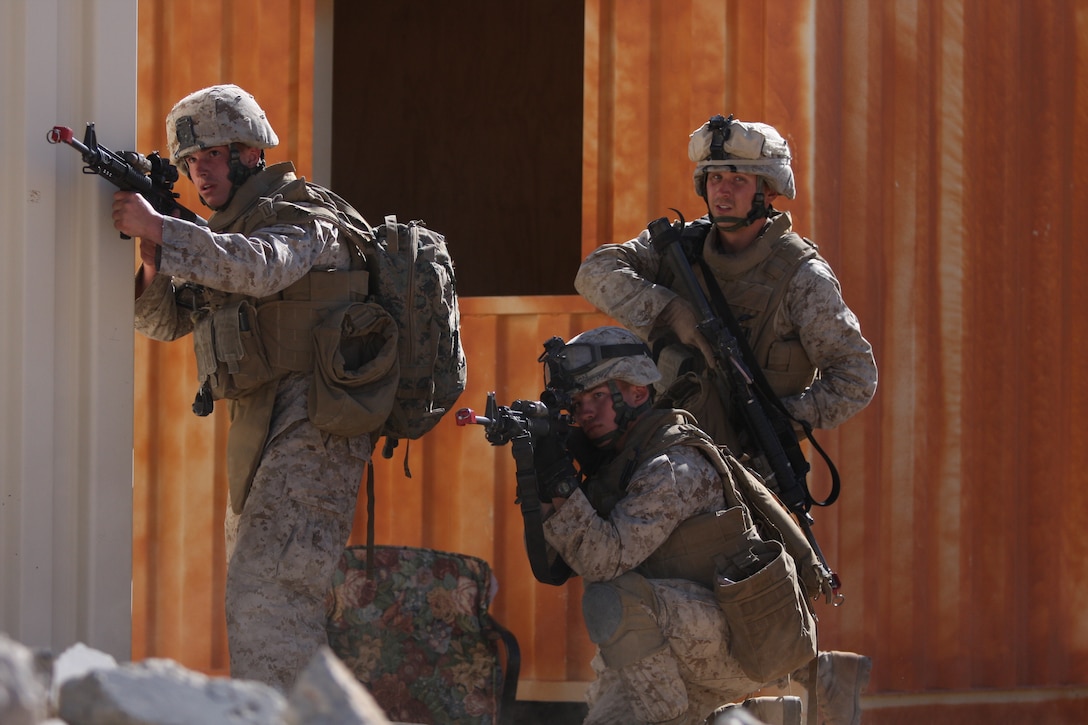 Weapons Platoon Marines from Company K, 3rd Battalion, 8th Marine Regiment, return fire from Taliban role during their patrol of a mock Afghan town at Range 215 as part of an Afghanistan-centered Mojave Viper at the Combat Center Sept. 20.