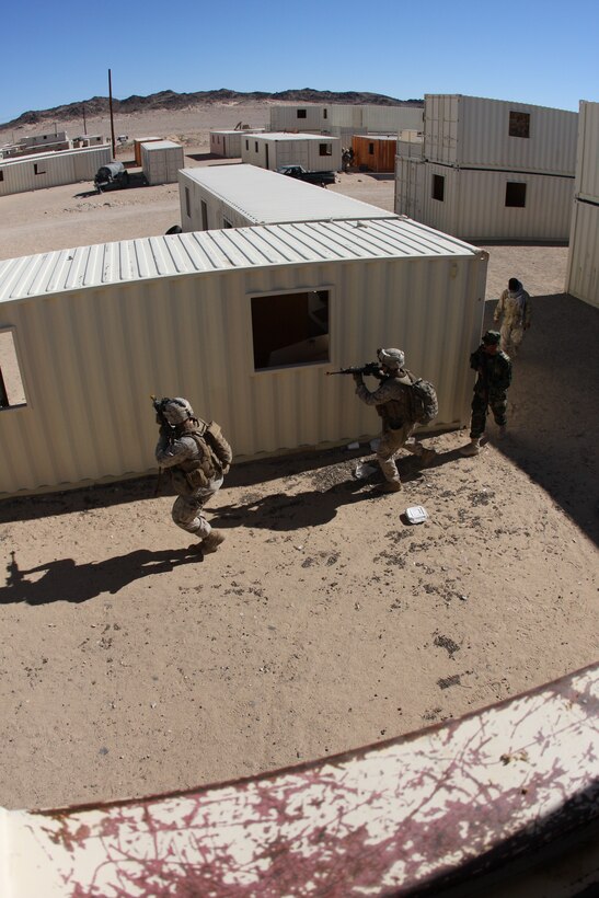 Marines with Company K, 3rd Battalion, 8th Marine Regiment, along with an Afghan National Army solider-role player and an interpreter search a mock Afghan town for a Taliban combatant during a patrol at Range 215 as part of an Afghanistan-centered Mojave Viper at the Combat Center Sept. 20.