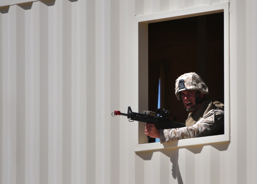 Cpl. Joseph Budrow, a squad leader with Company K’s Weapons Platoon, 3/8, yells fire commands during the raiding of a mock Taliban stronghold at Range 200 as part of an Afghanistan-centered Mojave Viper at the Combat Center Sept. 20.