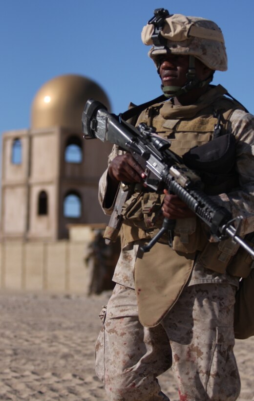 Pfc. Marvin Smoot, a mortarman with Company K’s Weapons Platoon, patrols a mock Afghani town during an Afghanistan-centered Mojave Viper at the Combat Center Sept. 17.