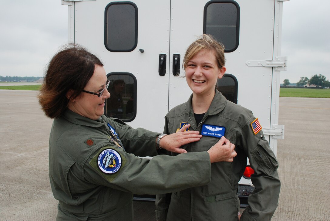 Staff Sgt. Aubrie Miskell pins on her new rank with the help of Maj. Linda Sitton just before leaving on a training mission to St. Croix in the U.S. Virgin Islands on an aeromedical training mission with the 932nd Airlift Wing, Air Force Reserve Command.  (U.S. Air Force photo by Tech. Sgt. Gerald Sonnenberg)
