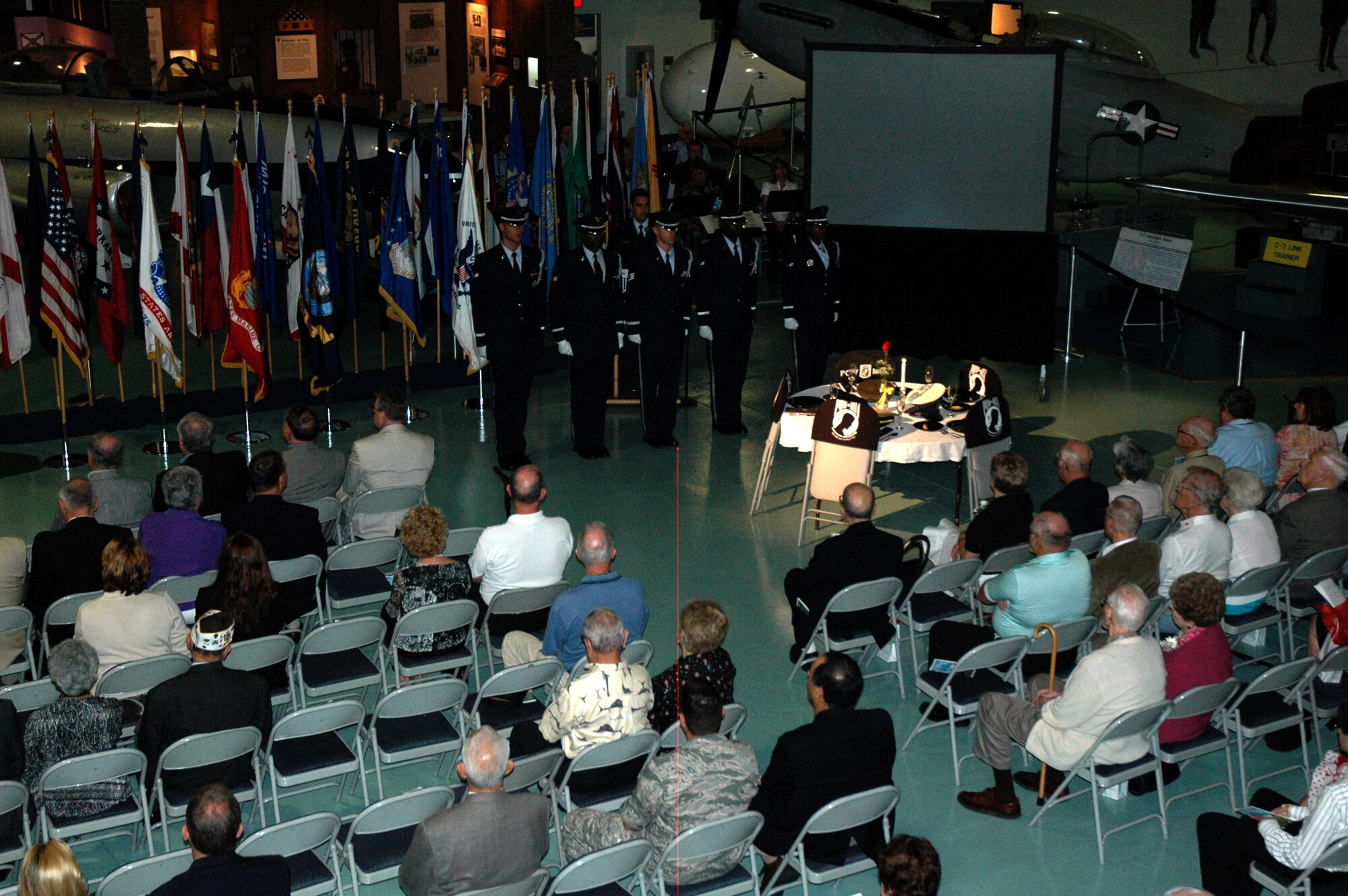 EGLIN AIR FORCE BASE, Fla. -- Members of the All Services Color Guard, and those who attended the POW/MIA Ceremony Sept. 19 at the Air Force Armament Museum, take a moment of silence and honor servicemembers who selflessly served the United States of America. The ceremony is symbolic and all elements of the POW/MIA table pay tribute to them. This year's ceremony marked the seventh year Team Eglin has hosted the event to honor the sacrifices servicemembers have given and endured in the name of defending the United States of America. (U.S. Air Force photo/Staff Sgt. Stacia Zachary)