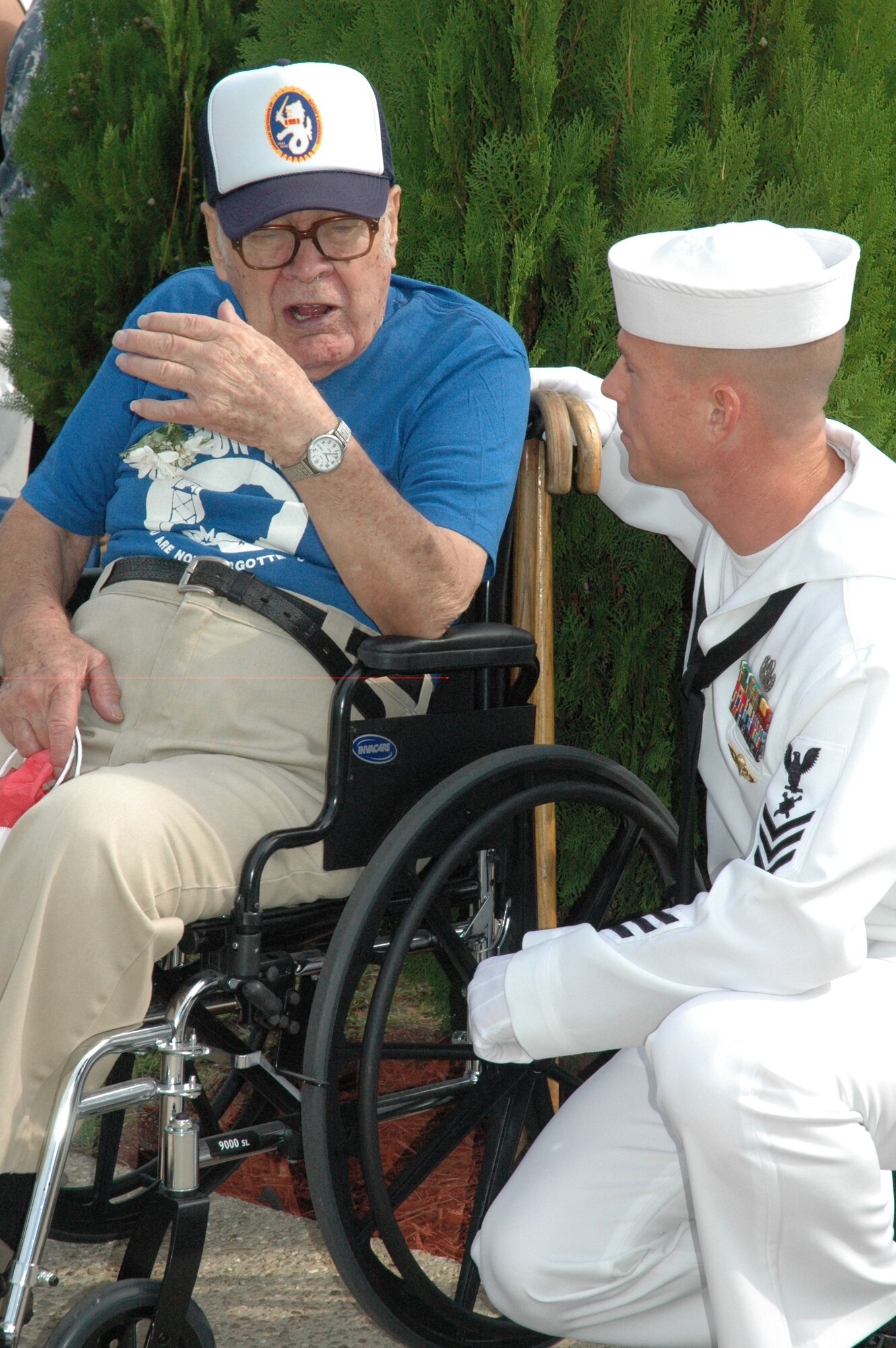 EGLIN AIR FORCE BASE, Fla. -- Former Prisoner of War Veteran Tech. Sgt. Peter Loss talks about his experiences while a member of the Air Force with Navy PO1 John Baum, a student attending Explosive Ordnance School here. Sergeant Loss was an honored guest at the POW/MIA Ceremony Sept. 19 at the Air Force Armament Museum. This year's ceremony marked the seventh year Team Eglin has hosted the event to honor the sacrifices servicemembers have given and endured in the name of defending the United States of America. (U.S. Air Force photo/Staff Sgt. Stacia Zachary)