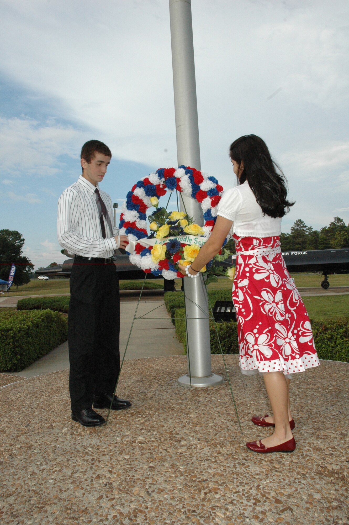 EGLIN AIR FORCE BASE, Fla. -- Travis Yates (Left) and Yasmin Hernandez, 8th grade students from Lewis Middle School, place the Lewis wreath during the POW/MIA ceremony Sept. 19 at the Air Force Armament Museum. This year's ceremony marked the seventh year Team Eglin hast hosted the event to honor the sacrifices servicemembers have given and endured in the name of defending the United States of America. (U.S. Air Force photo/Staff Sgt. Stacia Zachary)