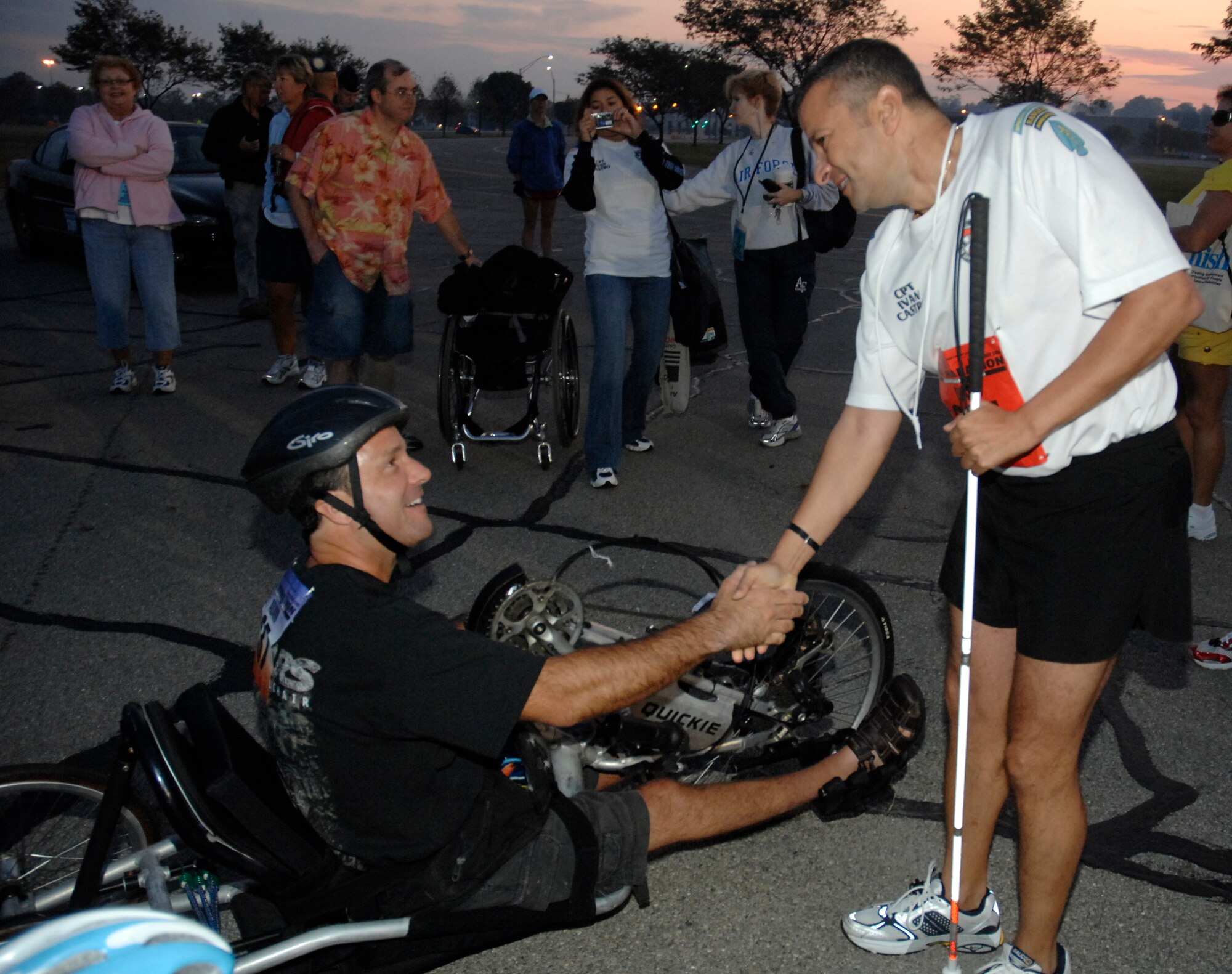 Wheelchair racer Andrew Houghton and Army Capt. Ivan Castro exchange best wishes prior to the start of the U.S. Air Force Marathon at Wright-Patterson Air Force Base, Ohio on Saturday, Sept. 20.  Castro, who is blind as a result of combat injuries sustained in Iraq, ran tethered alongside Lt. Col. Fred Dummar.  Both special forces officers are assigned to Fort Bragg, N.C.  Houghton is chairperson for the Committee for Purchase From People Who Are Blind or Severely Disabled. (U.S. Air Force photo/Al Bright)