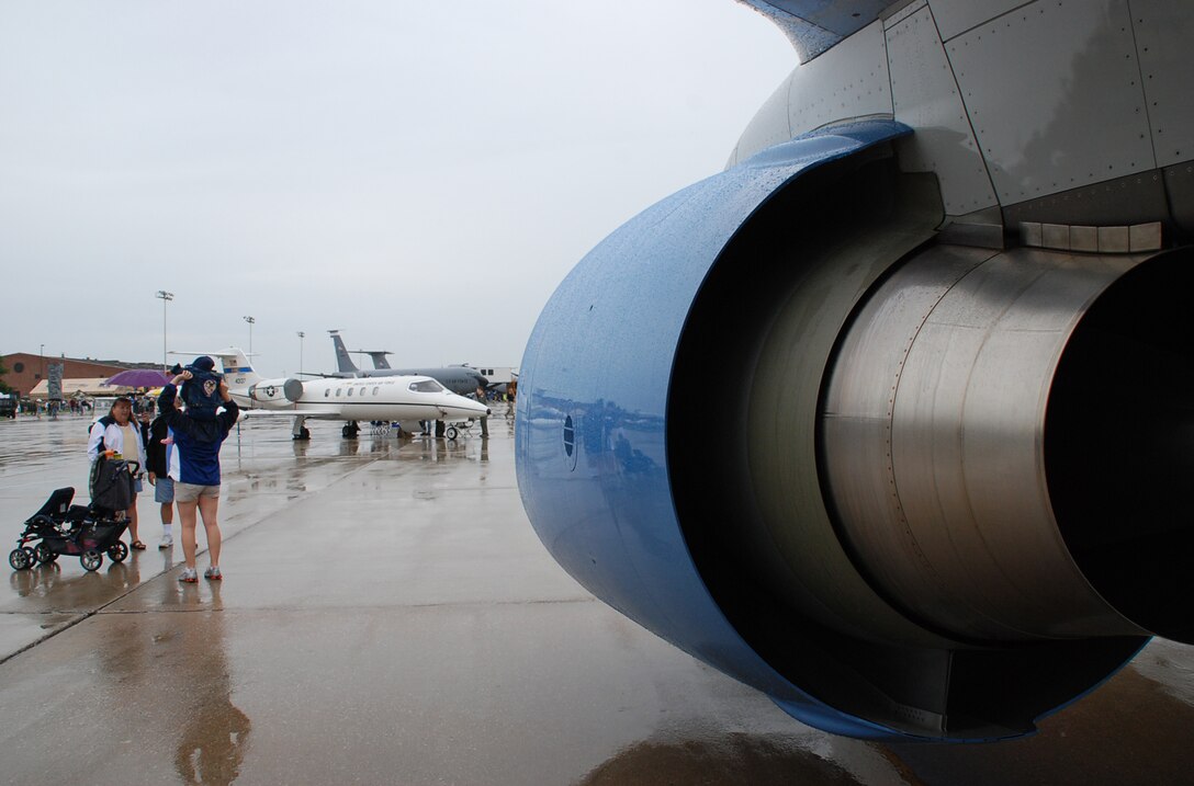 Visitors to Airshow 2008 check out the 932nd Airlift Wing's C-40C distinguished visitor airlift plane during the early hours as rain fell.  The weather cleared out later and the Thunderbirds flew a great show.  (U.S. Air Force photo by Maj. Stan Paregien)