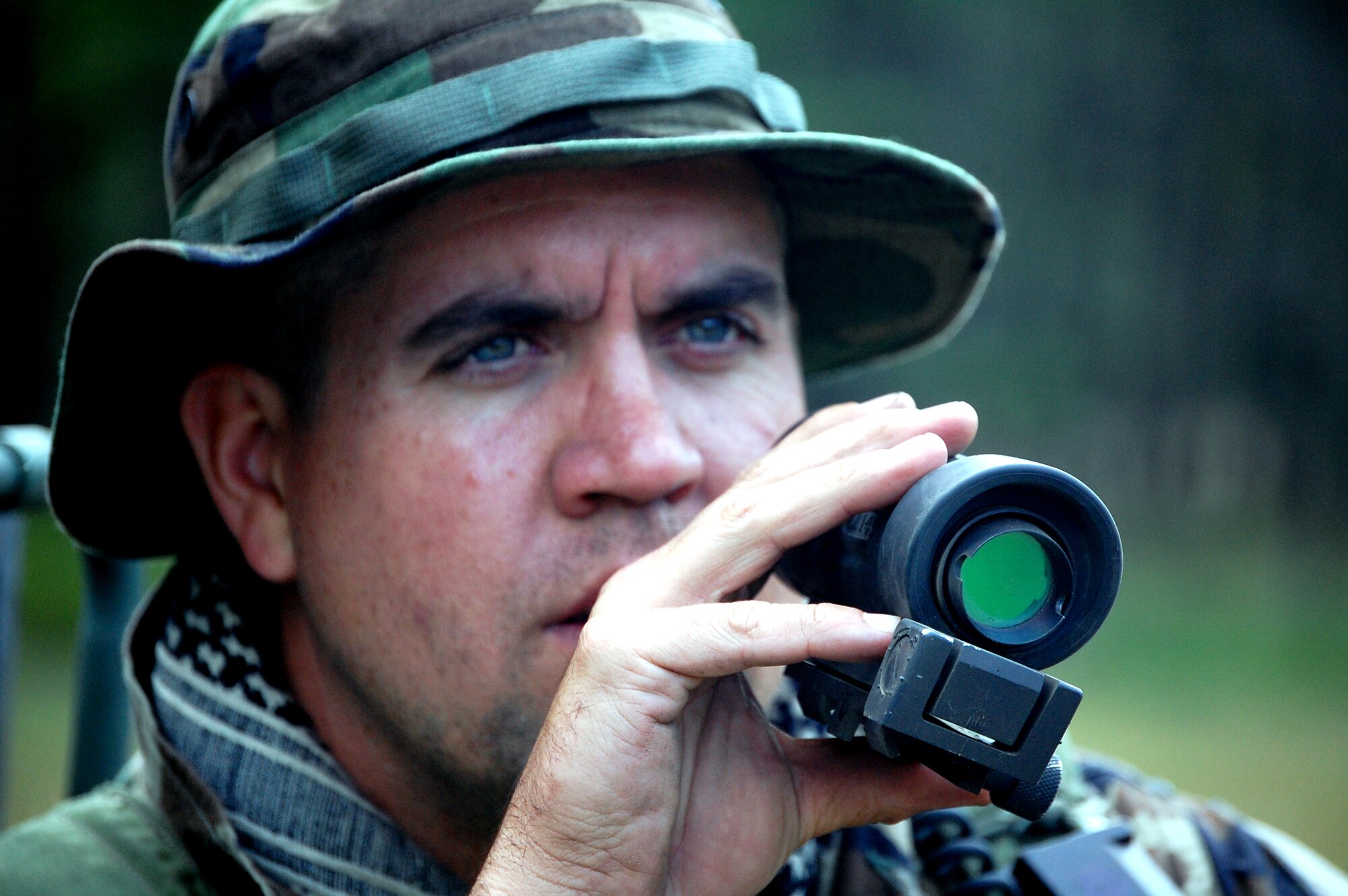 Staff Sgt. Scott Strickland, from the 816th Contingency Response Group, McGuire Air Force Base, N.J., peers through a scope during a scenario for Air Force Exercise Eagle Flag 08-6 Sept. 19, 2008, at Naval Air Engineering Station Lakehurst, N.J.  The exercise, managed by the U.S. Air Force Expeditionary Center's 421st Combat Training Squadron from Fort Dix, N.J., tests and trains more than 400 Airmen in expeditionary combat support skills.  (U.S. Air Force Photo/Tech. Sgt. Scott T. Sturkol)