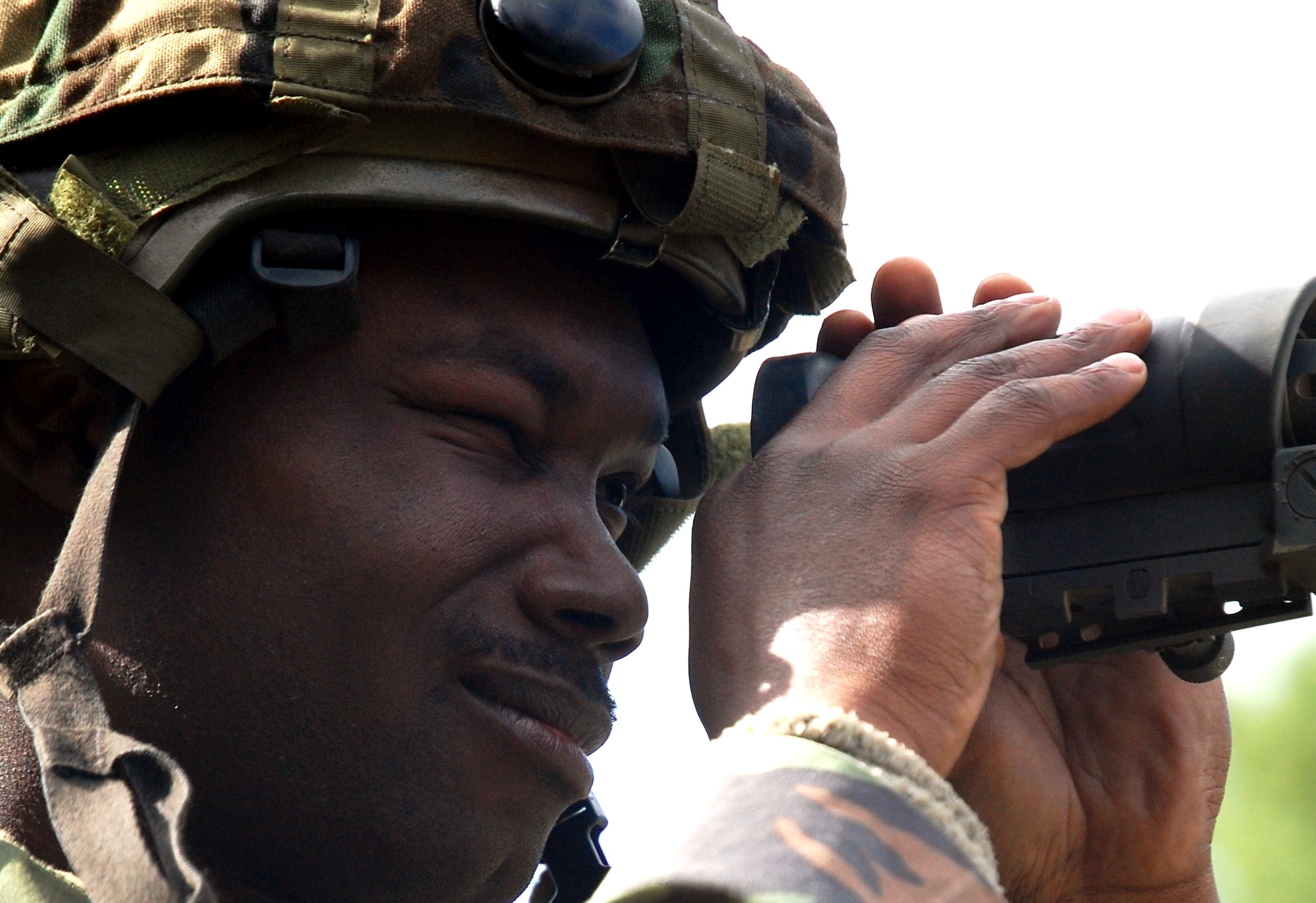 Staff Sgt. Billy Smithshelley, from the 816th Contingency Response Group, McGuire Air Force Base, N.J., peers through a scope during a scenario for Air Force Exercise Eagle Flag 08-6 Sept. 19, 2008, at Naval Air Engineering Station Lakehurst, N.J.  The exercise, managed by the U.S. Air Force Expeditionary Center's 421st Combat Training Squadron from Fort Dix, N.J., tests and trains more than 400 Airmen in expeditionary combat support skills.  (U.S. Air Force Photo/Tech. Sgt. Scott T. Sturkol)