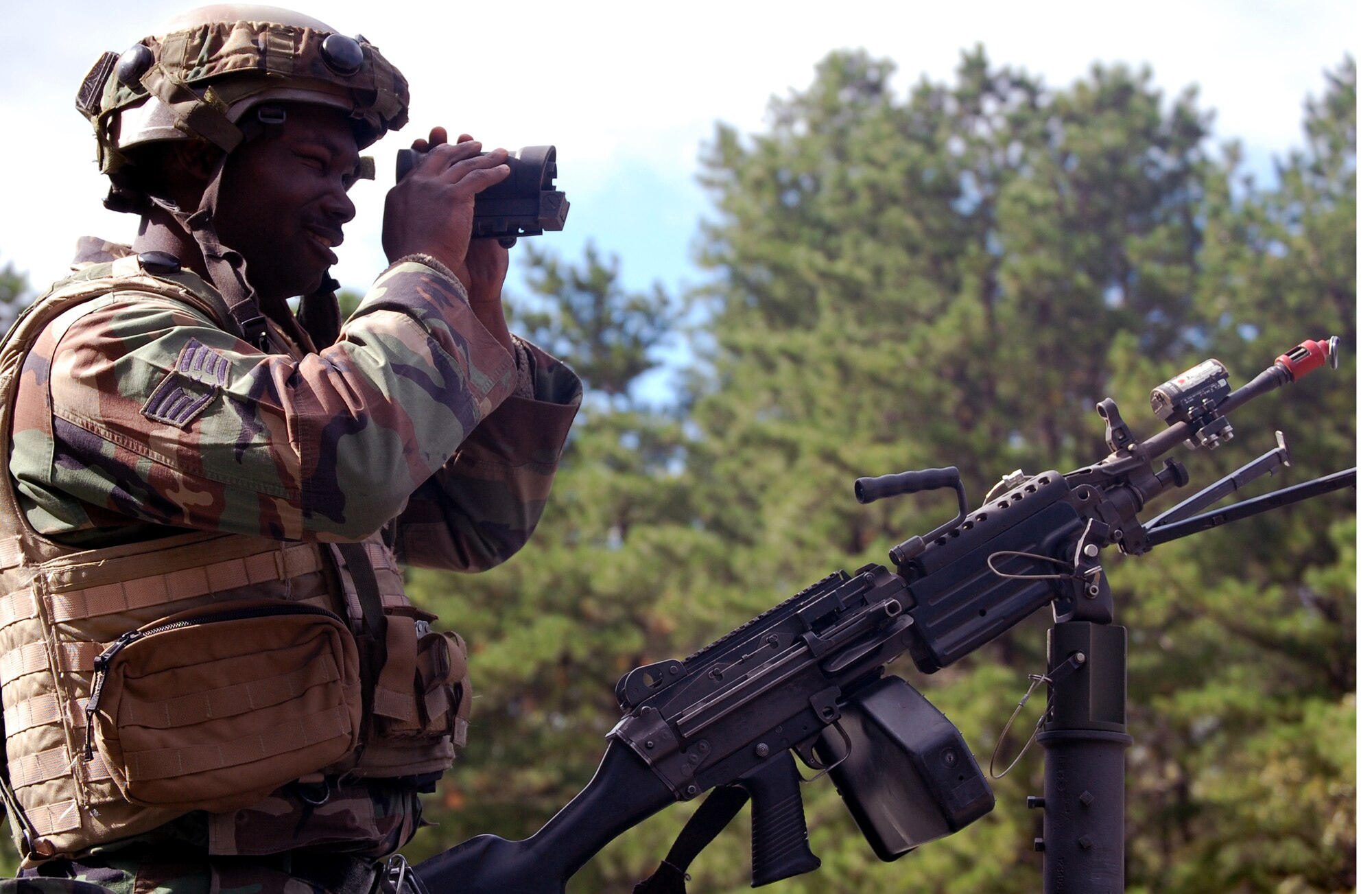 Staff Sgt. Billy Smithshelley, from the 816th Contingency Response Group, McGuire Air Force Base, N.J., peers through a scope during a scenario for Air Force Exercise Eagle Flag 08-6 Sept. 19, 2008, at Naval Air Engineering Station Lakehurst, N.J.  The exercise, managed by the U.S. Air Force Expeditionary Center's 421st Combat Training Squadron from Fort Dix, N.J., tests and trains more than 400 Airmen in expeditionary combat support skills.  (U.S. Air Force Photo/Tech. Sgt. Scott T. Sturkol)